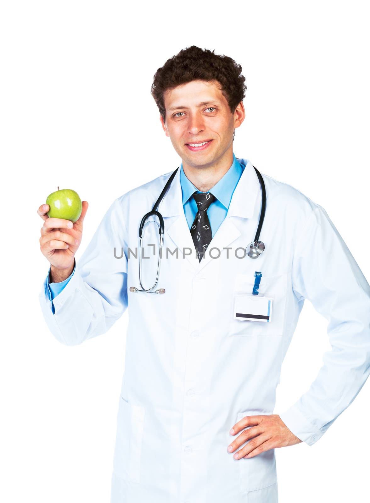 Portrait of a smiling male doctor holding green apple on white background