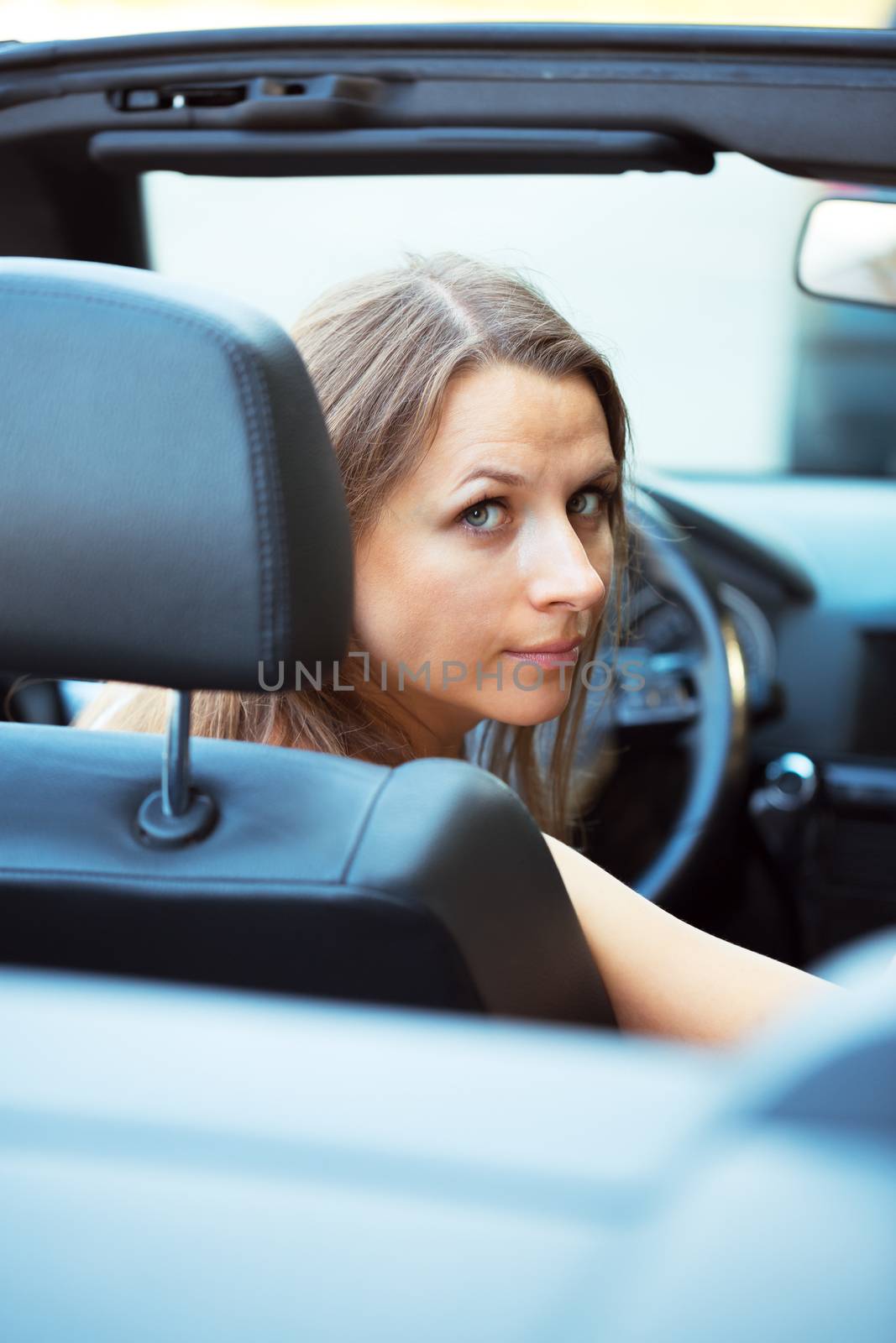 Caucasian woman in a cabriolet car