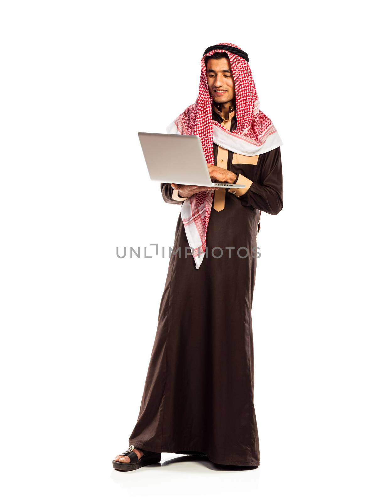 Young smiling arab with laptop isolated on white background