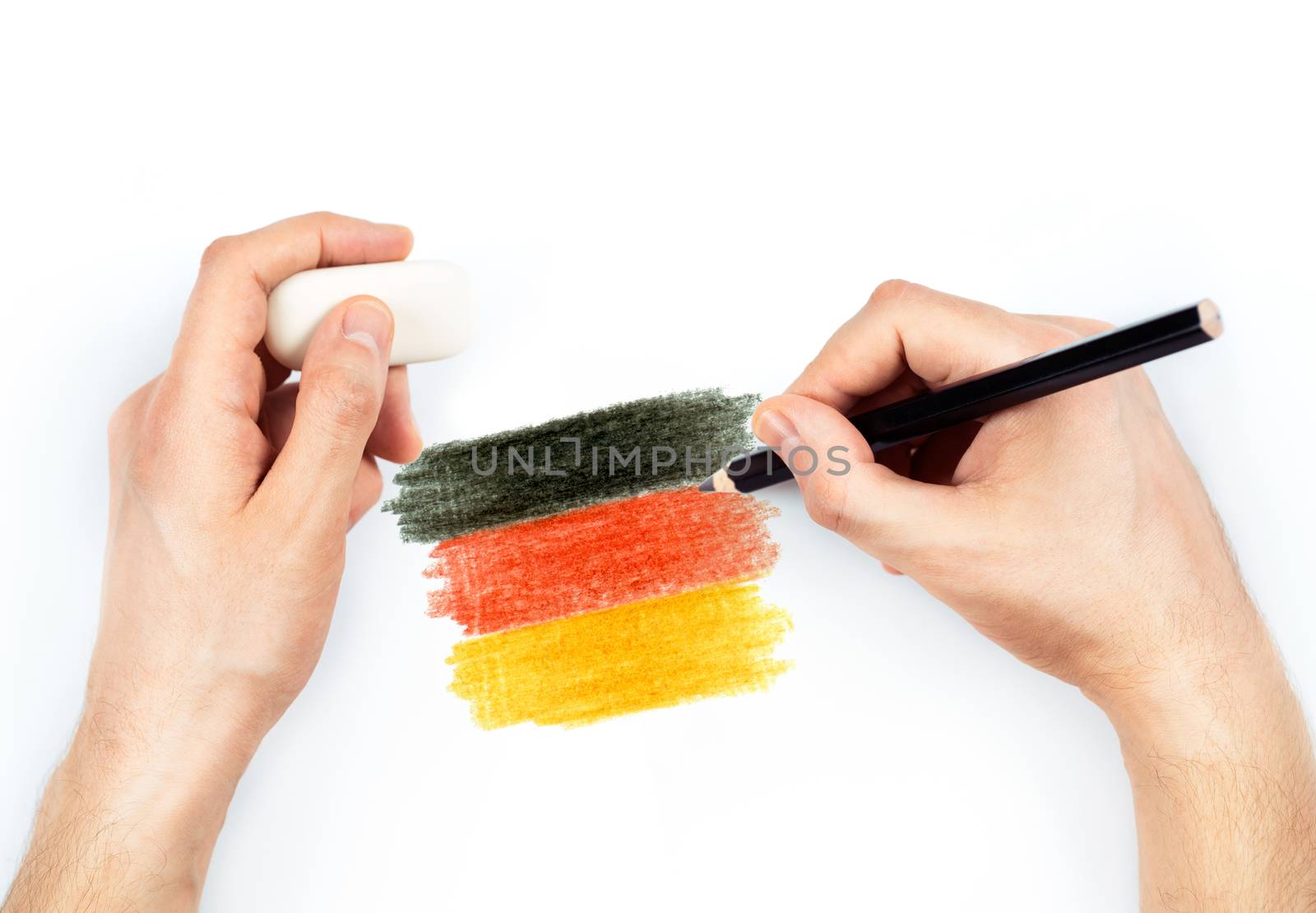 Man's hands with pencil draws flag of Germany on white background