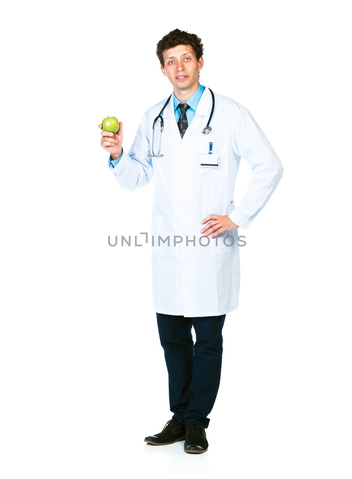 Portrait of a smiling male doctor holding green apple on white background