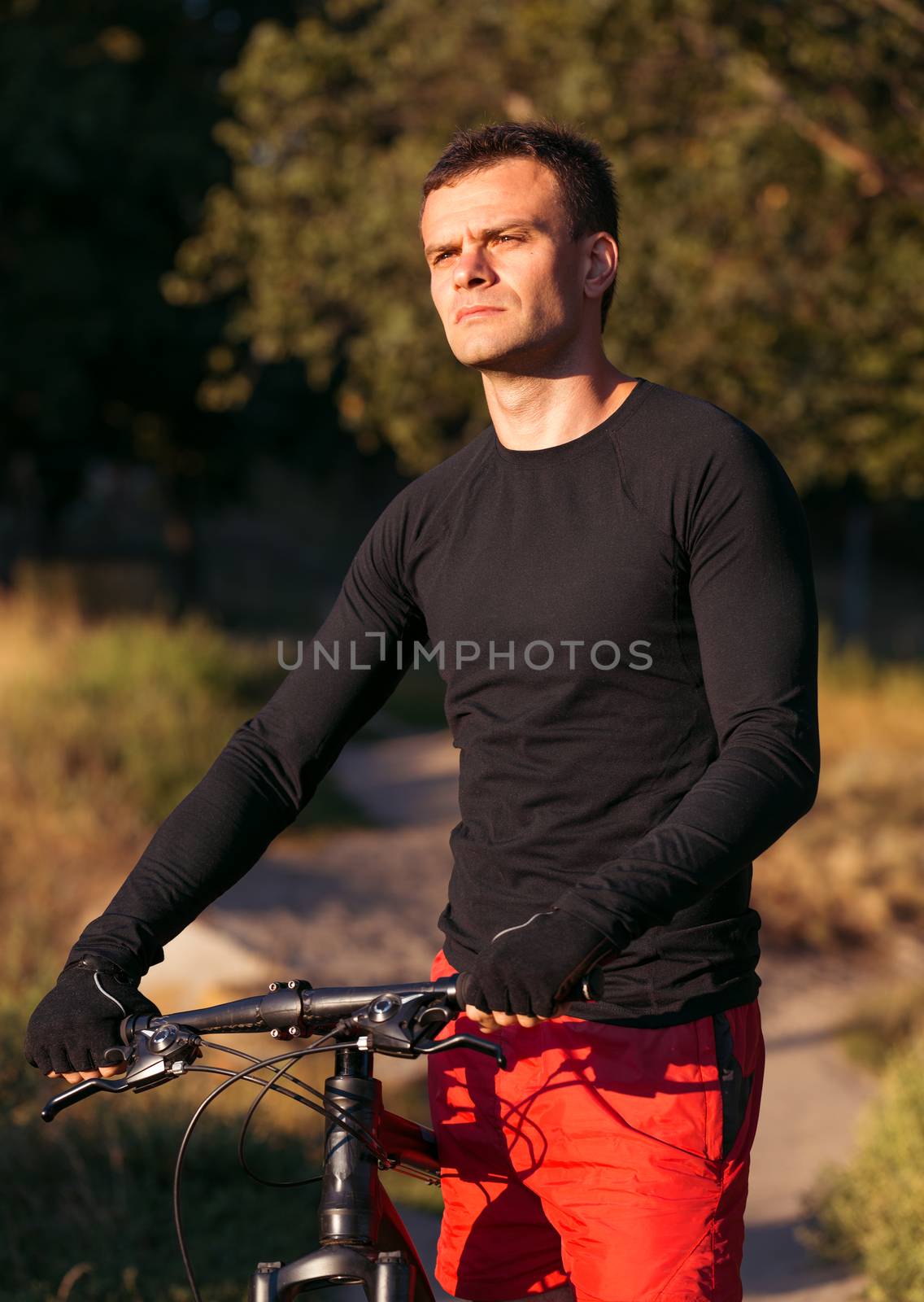 Mountain bike cyclist riding at sunrise healthy lifestyle doing  by vlad_star