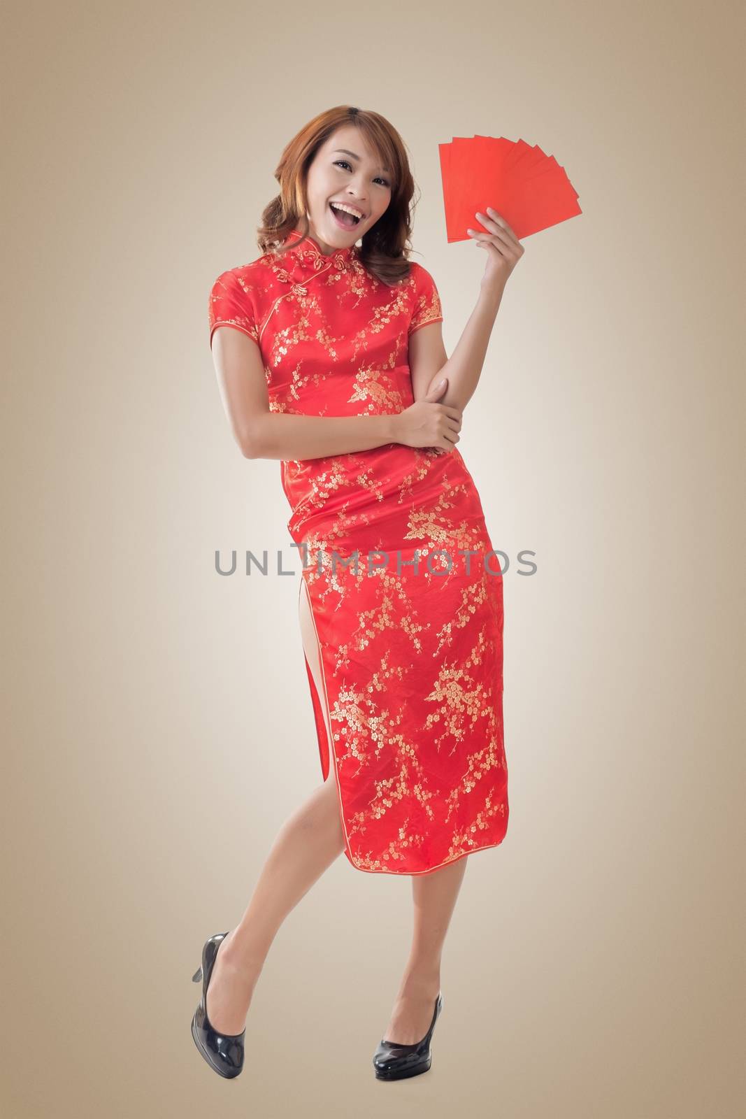 Attractive Chinese woman dress traditional cheongsam and hold red envelope, closeup portrait.