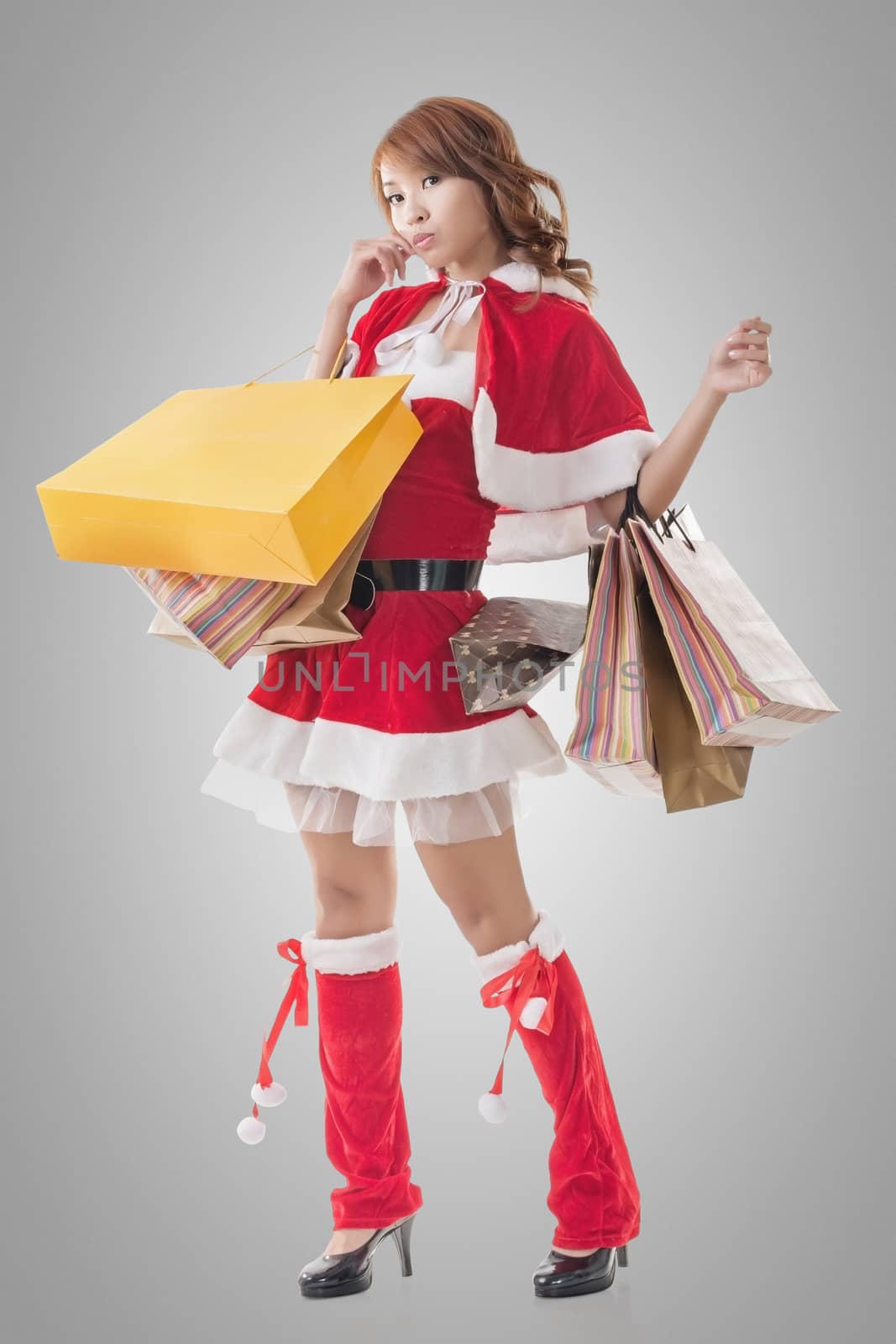 Asian Christmas girl hold shopping bags, full length portrait.