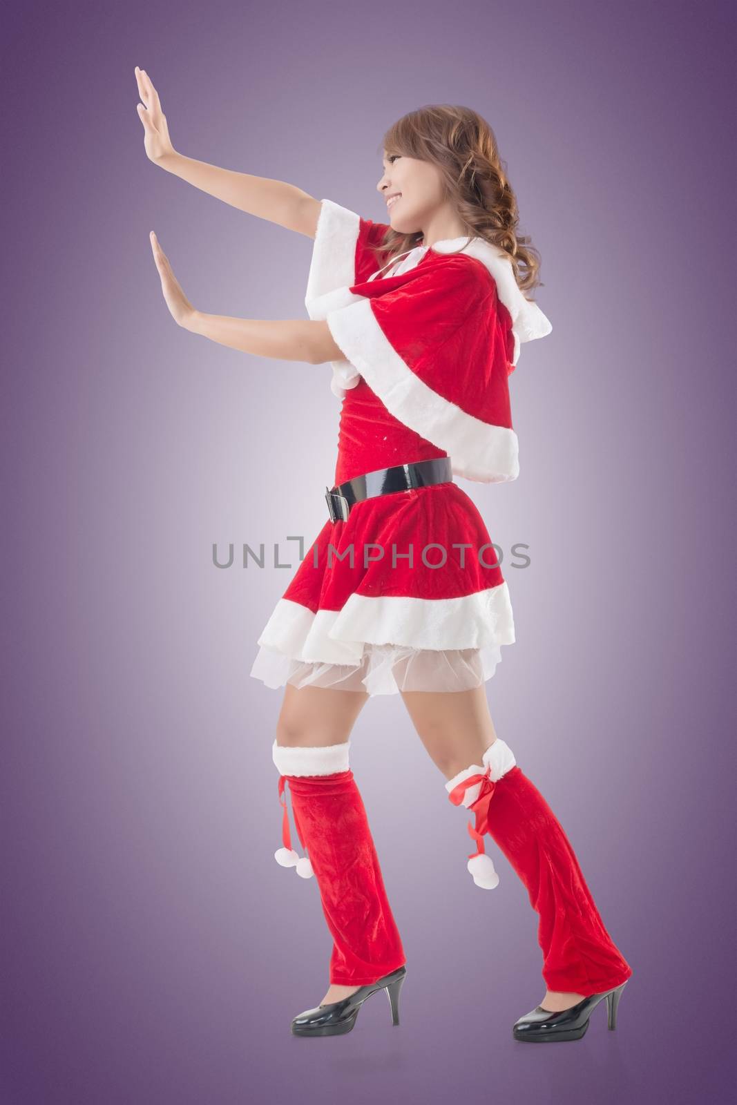 Christmas girl push something, full length pose isolated.