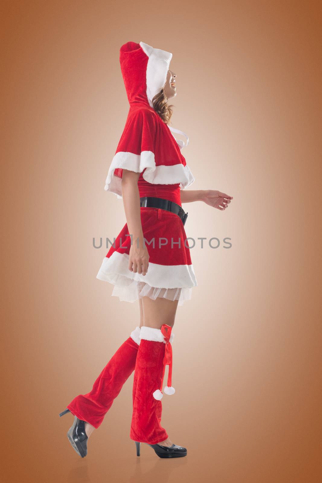 Asian Christmas girl walk, full length portrait. Side view.