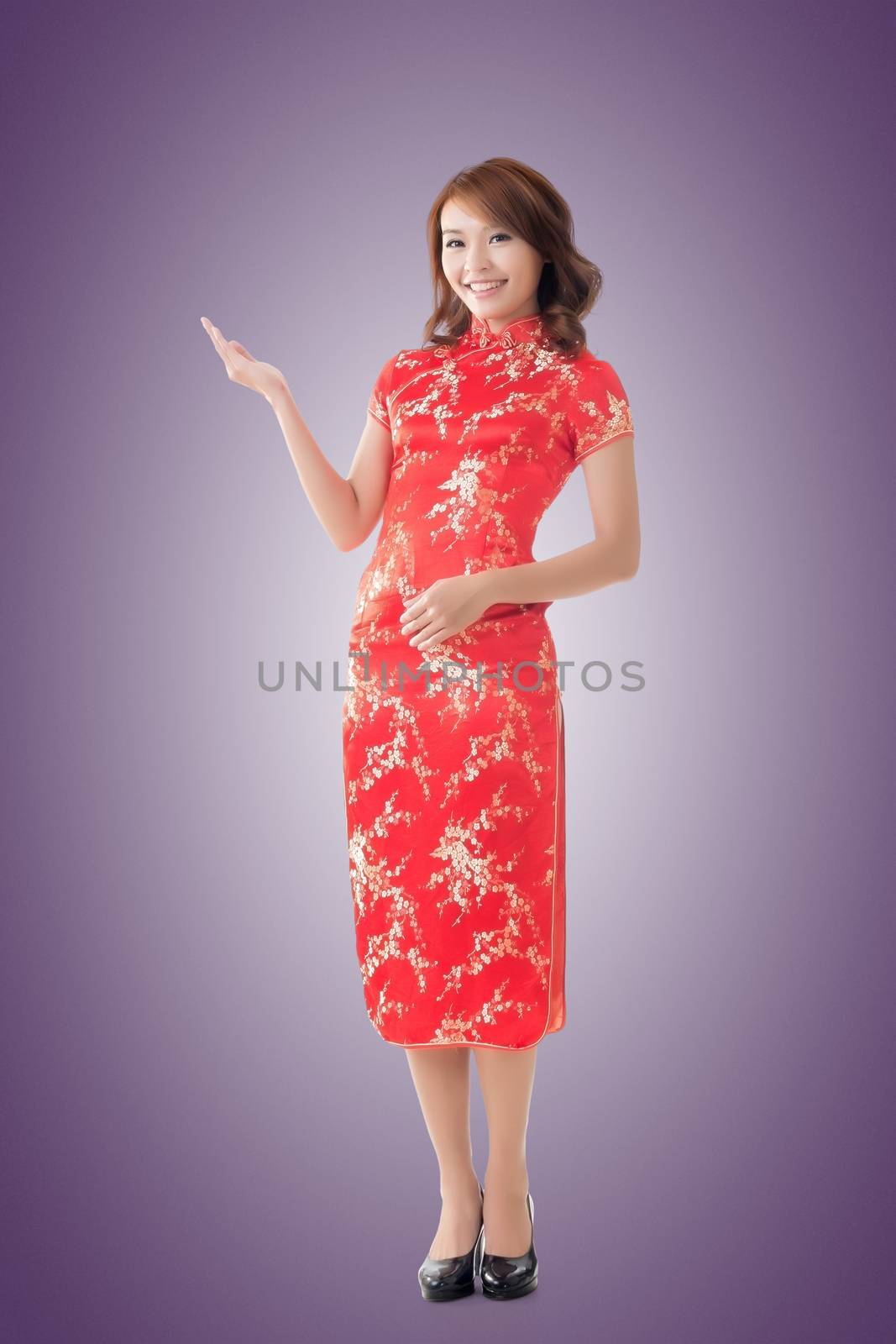 Chinese woman dress traditional cheongsam at New Year and introducing, full length portrait isolated.