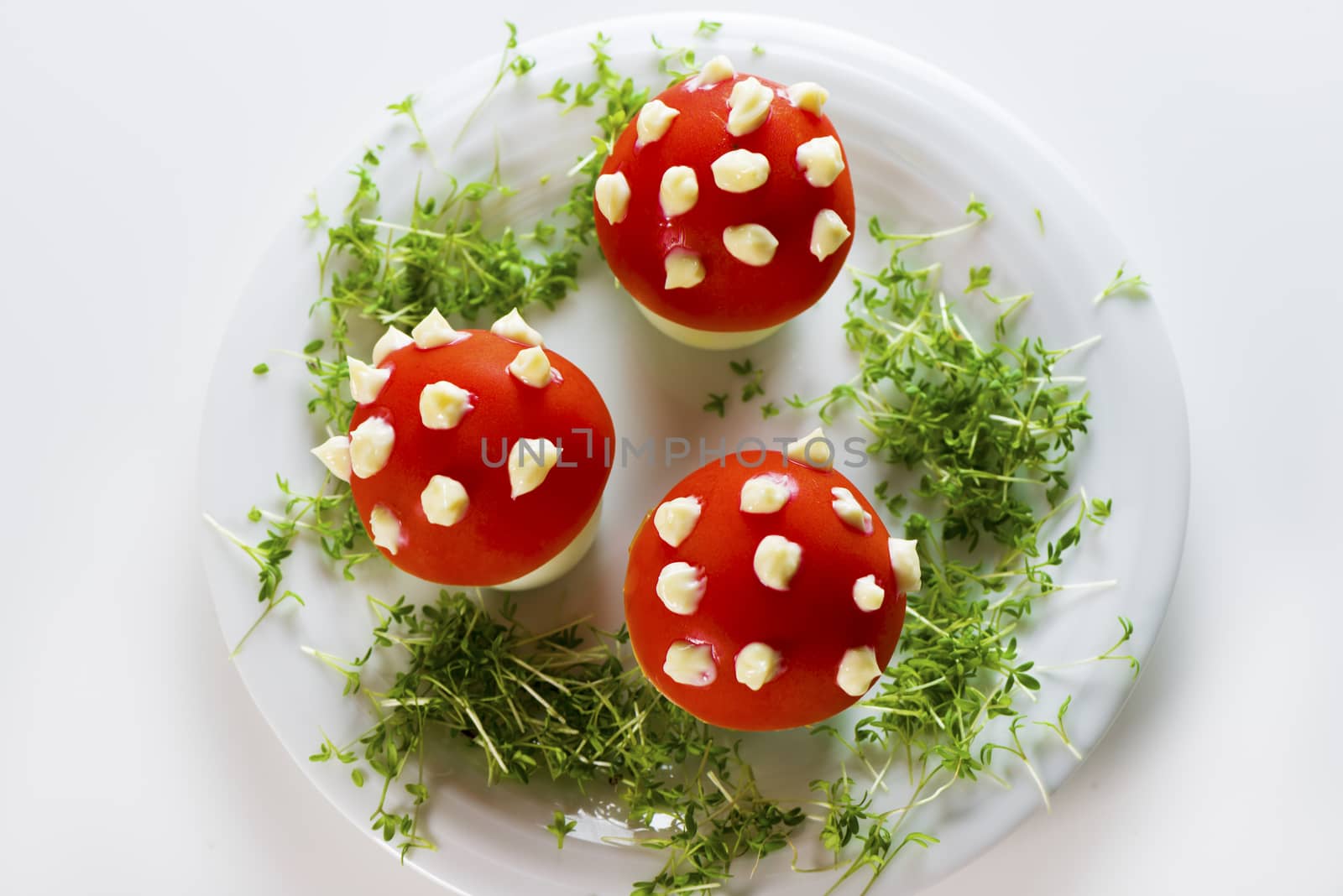Fly mushroom formed from boiled egg, cover with the tomato mayonnaise. Funny food for children or party.