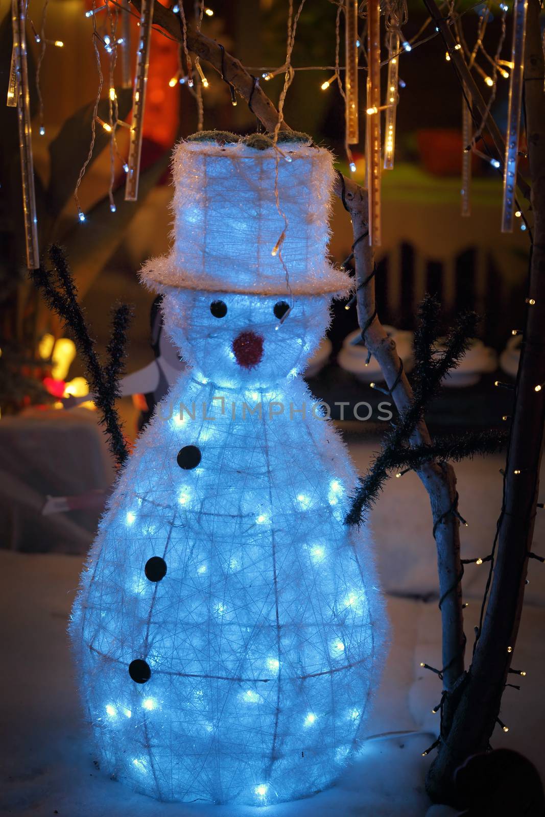 LALOR PARK, AUSTRALIA - DECEMBER 23, 2014;  Snowman with tophat on snow scene toy figure and christmas decorations and lights display