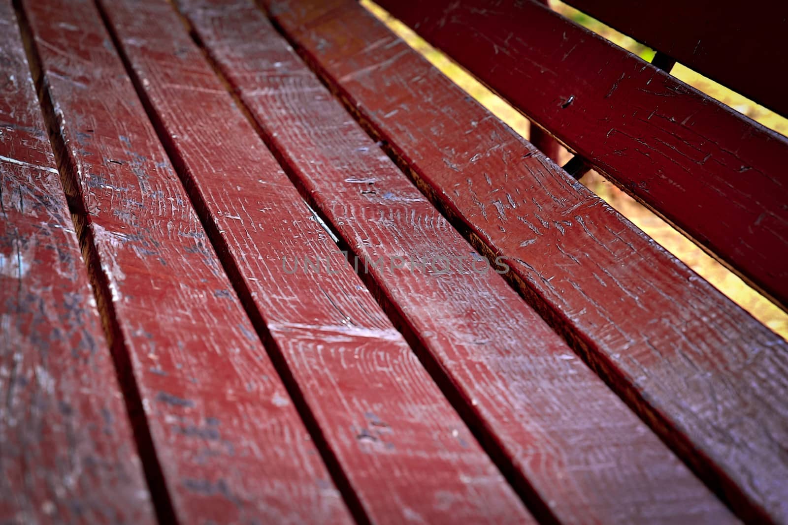 background detail of a wooden benches in the park burgundy color