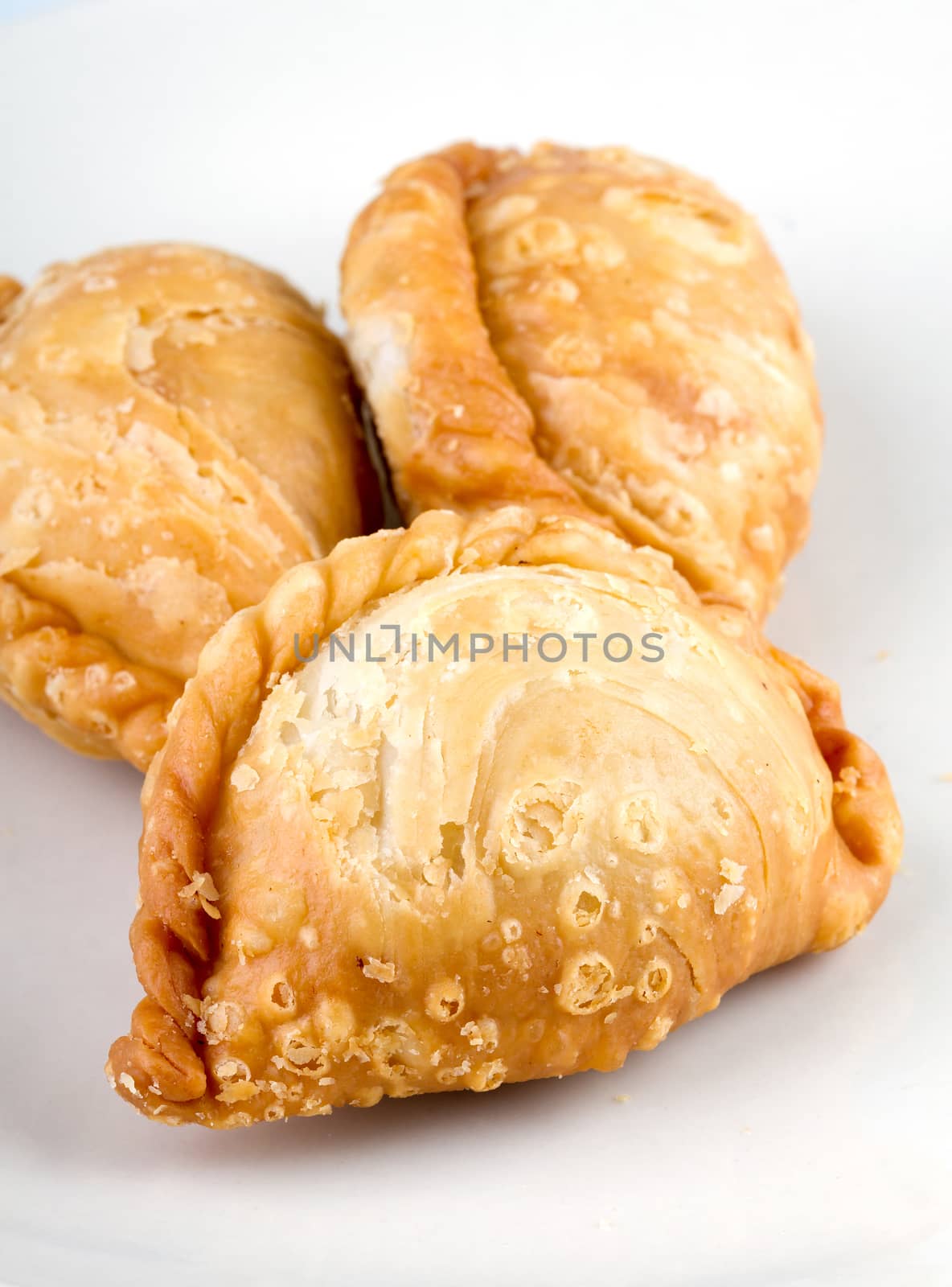 delicious fried Curry Puffs on white dish