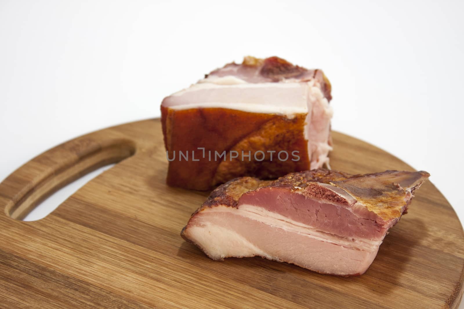 Pork ribs on wooden board on the white background.