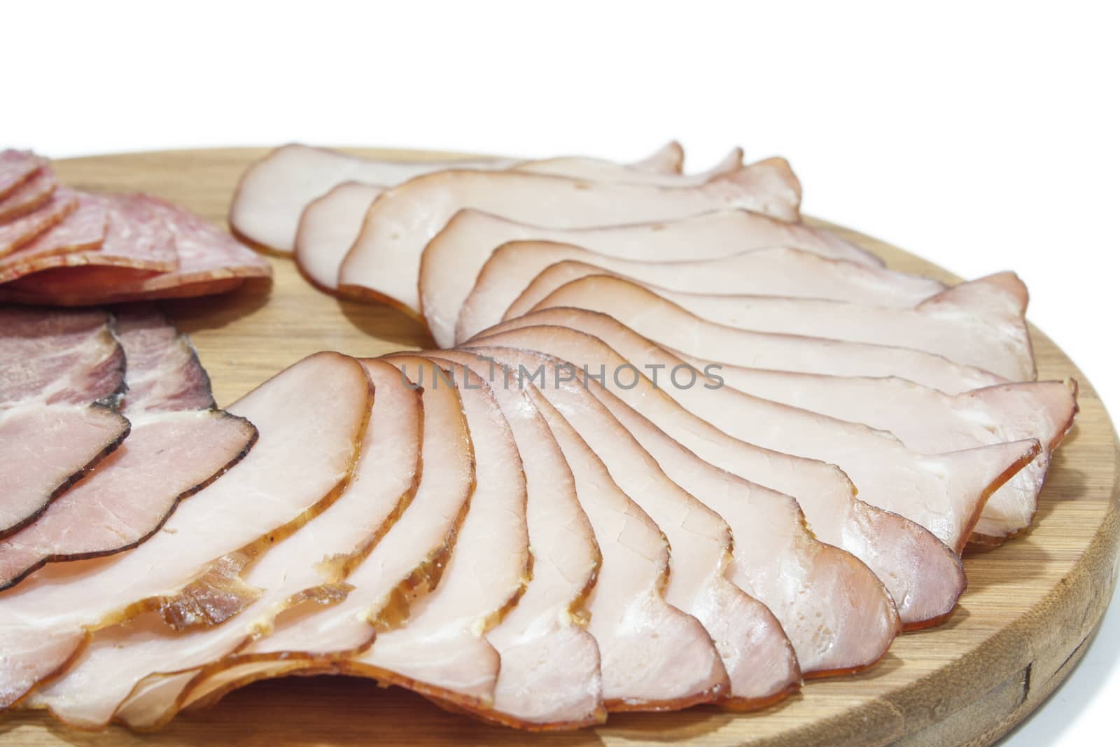 Cutted smoked sirloin, smoked ham and sausage on a wooden board by zlajaphoto