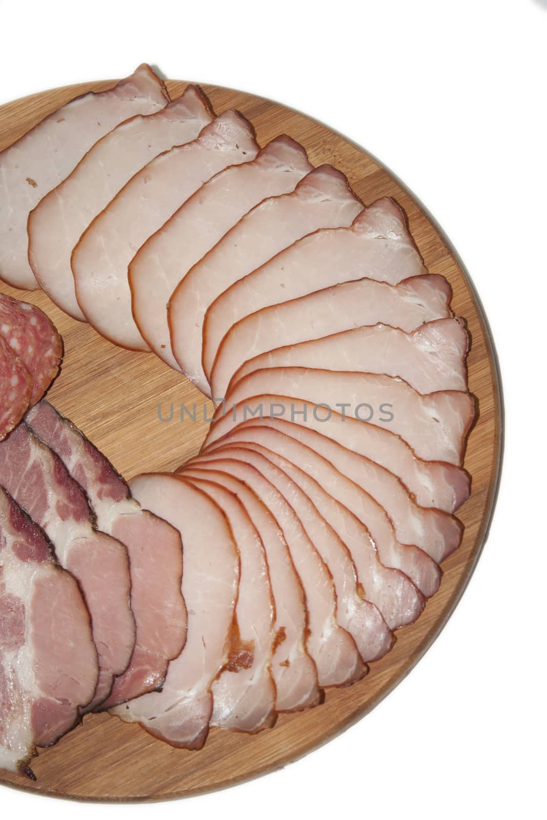 Cutted smoked sirloin on a wooden board on the white background.