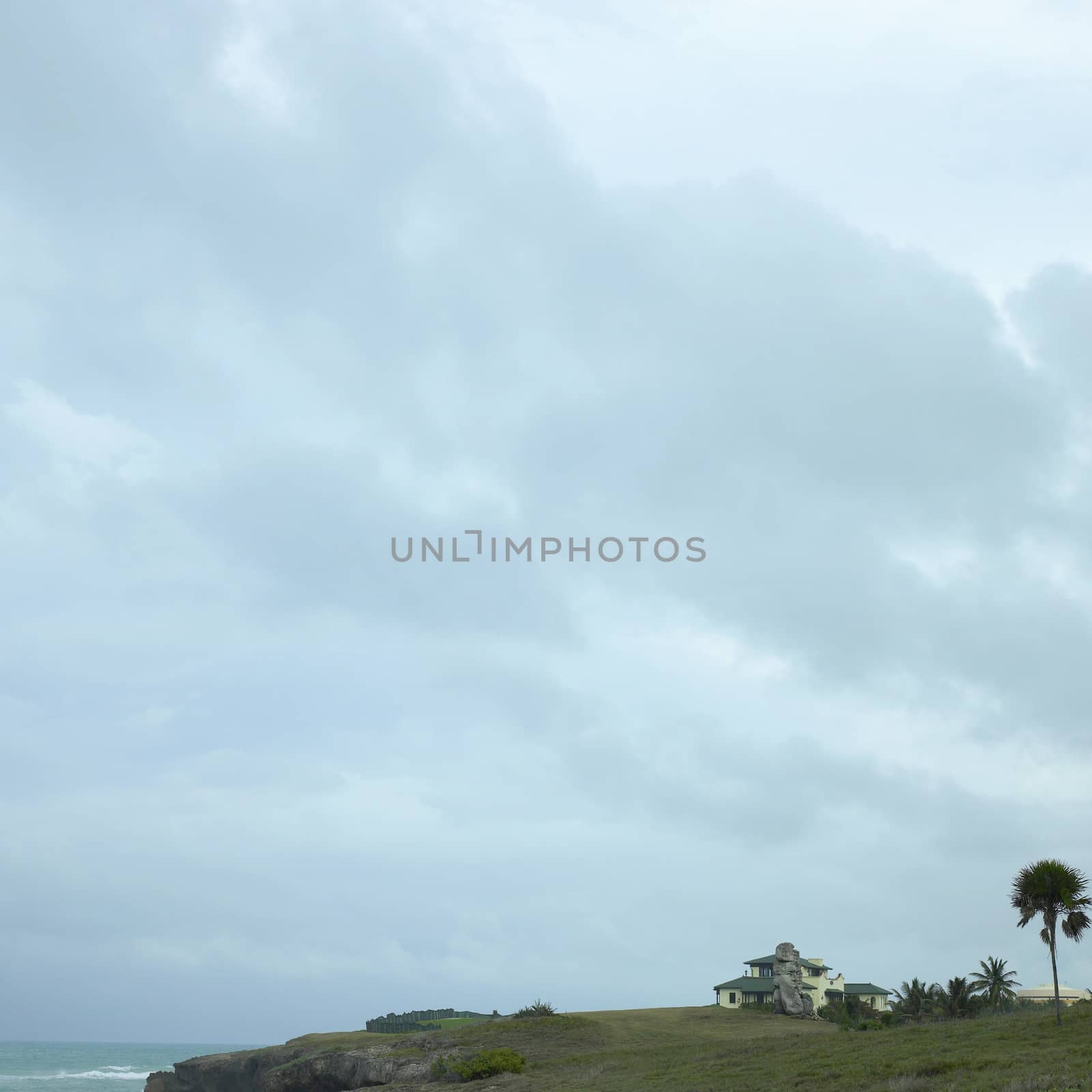 Large vila on a cliff by the tropical ocean