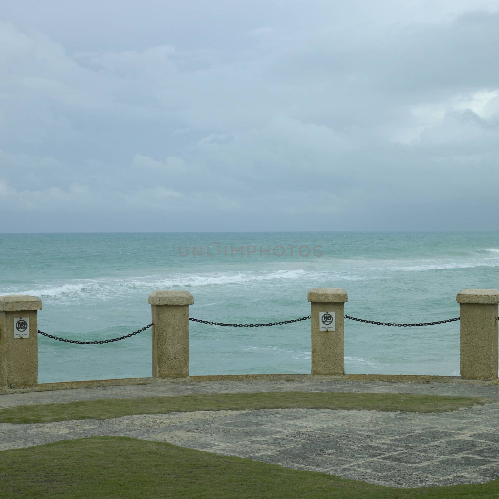 Pillar and chain fence overlooking the tropical ocean