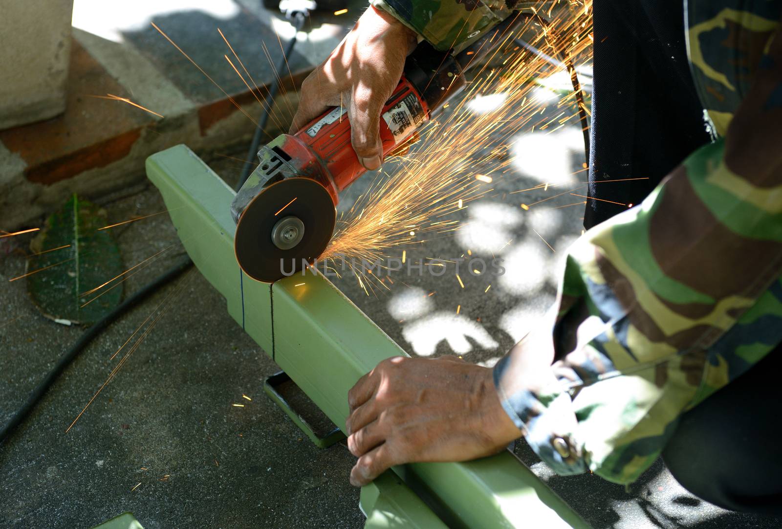 Electric wheel grinding on steel structure of car parking