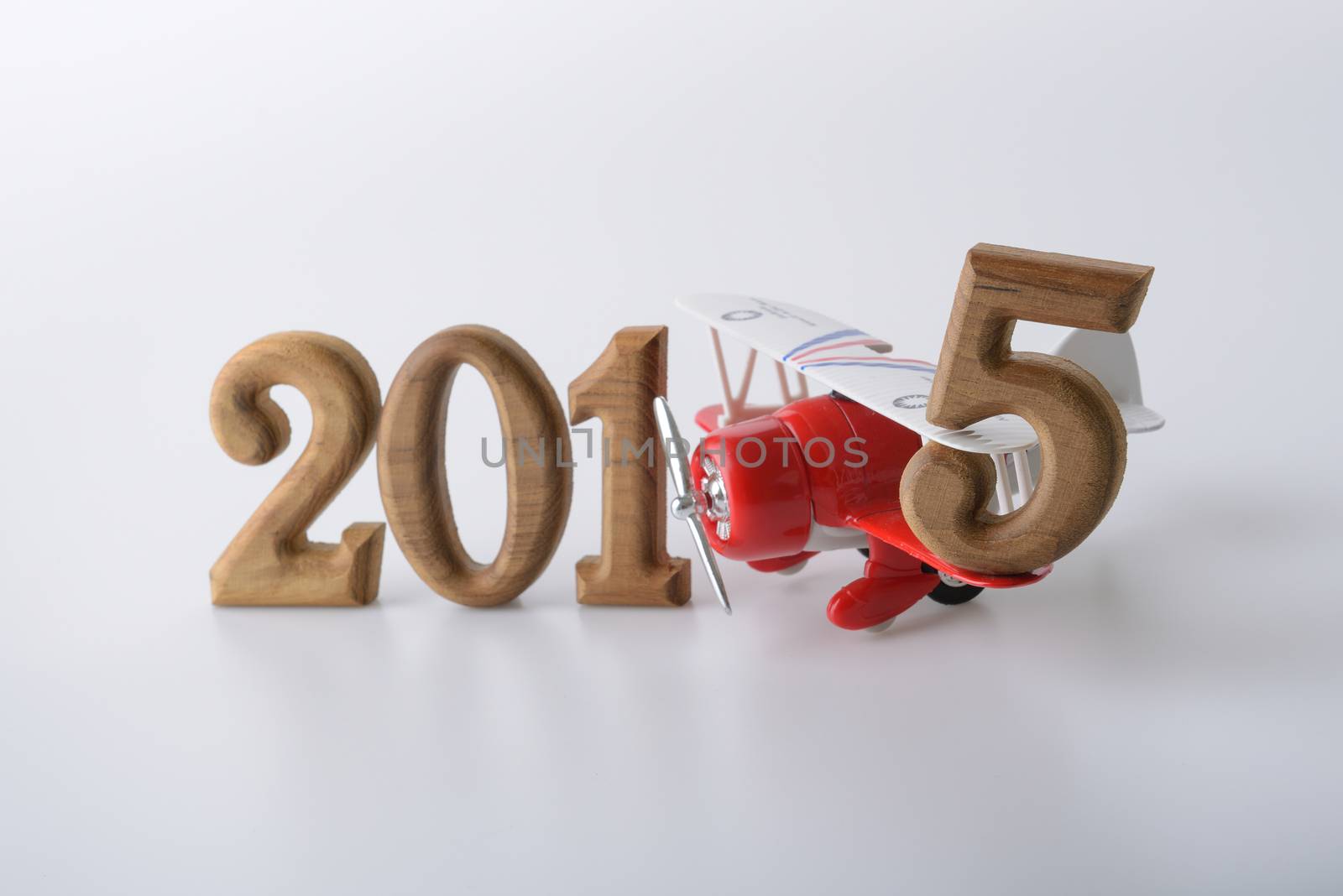 New year 2015 sign made by wooden number and red toy airplane
