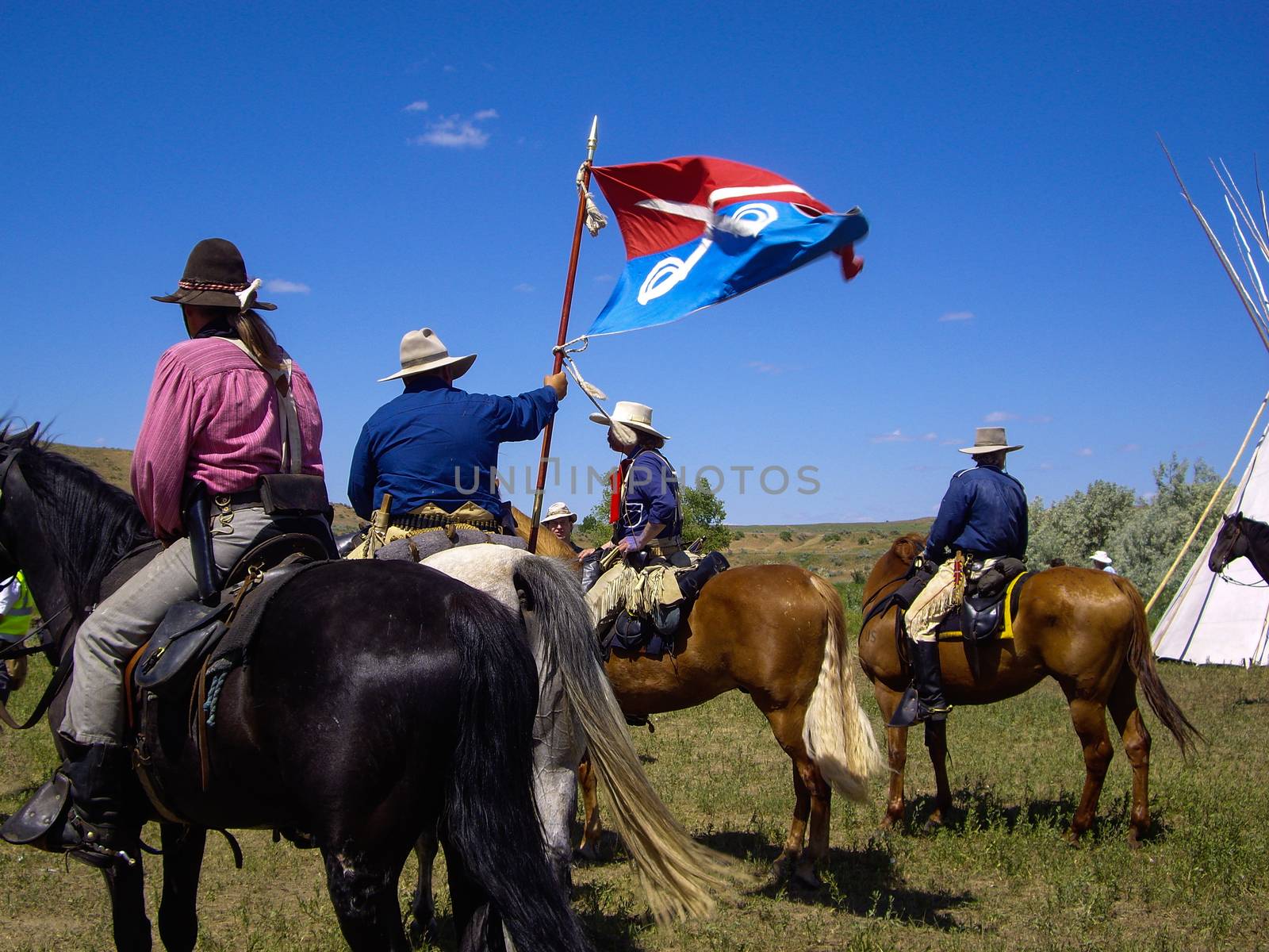 Crow Agency, Montana USA - June 27, 2009: Reenactment of the Battle of the Little Bighorn known as Custer's Last Stand. U.S. 7th Cavalry soldiers raise their standard flag on the battle field.