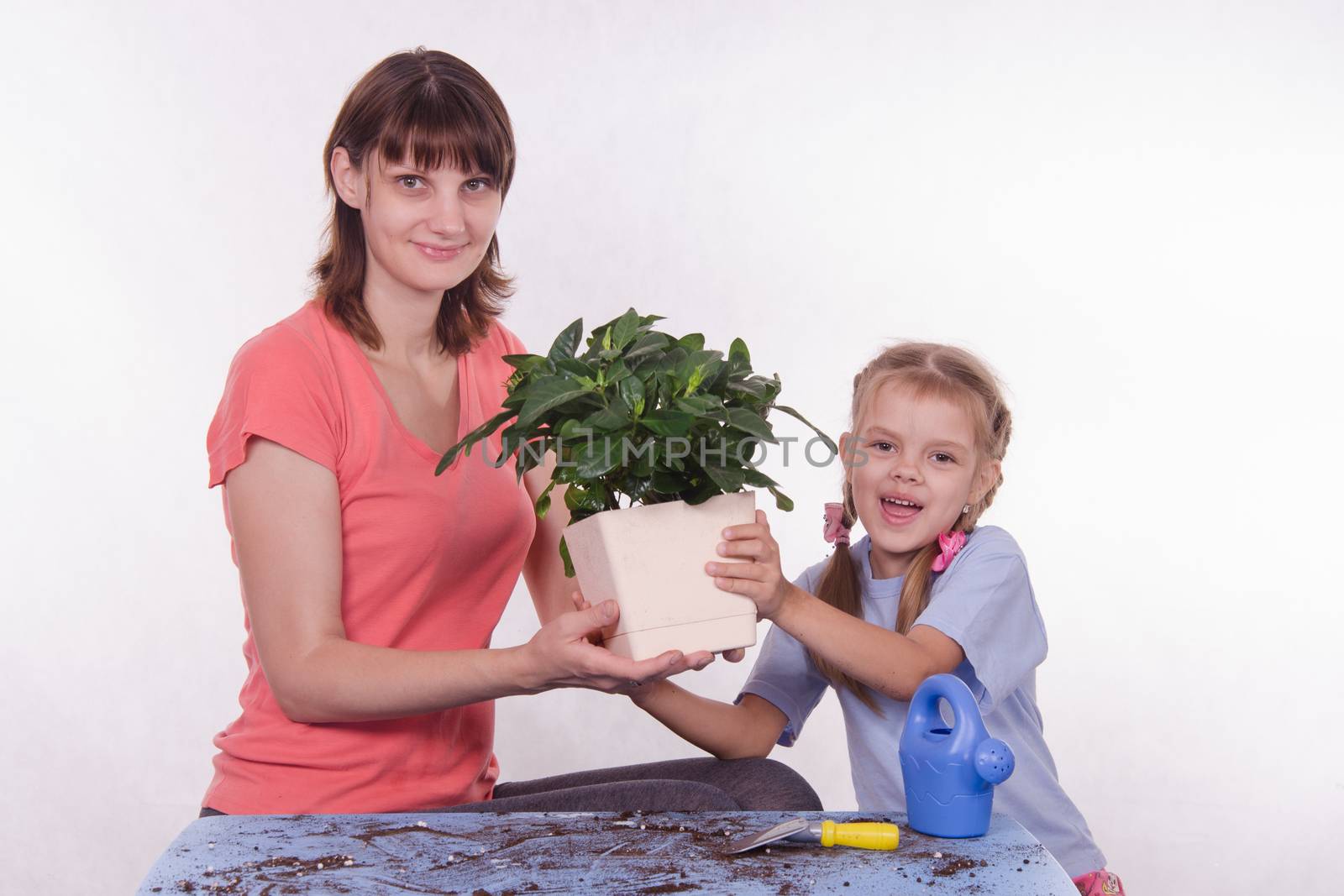 Mom and daughter holding hands in the flower room by Madhourse