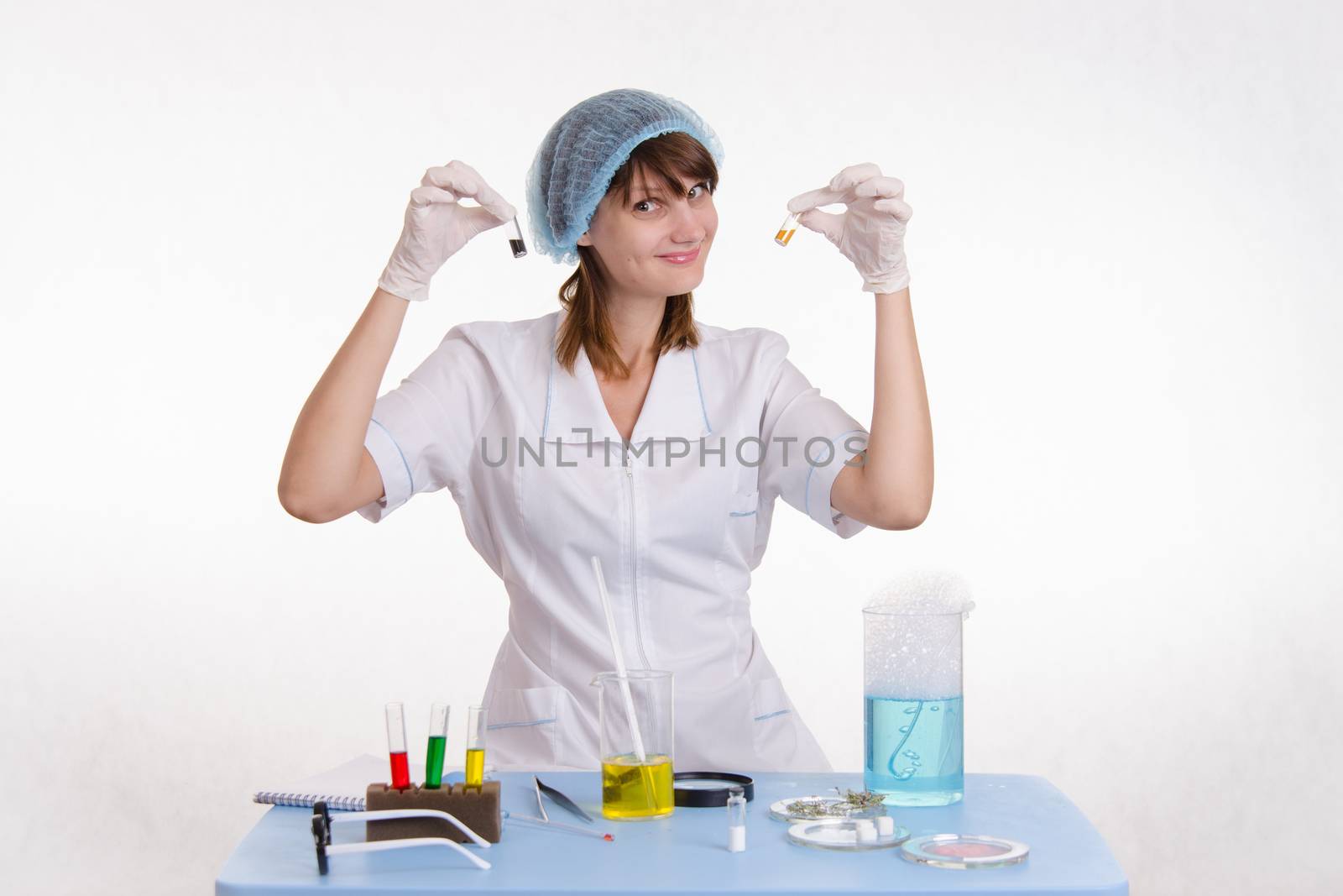 Young beautiful girl posing chemical experiments in the laboratory
