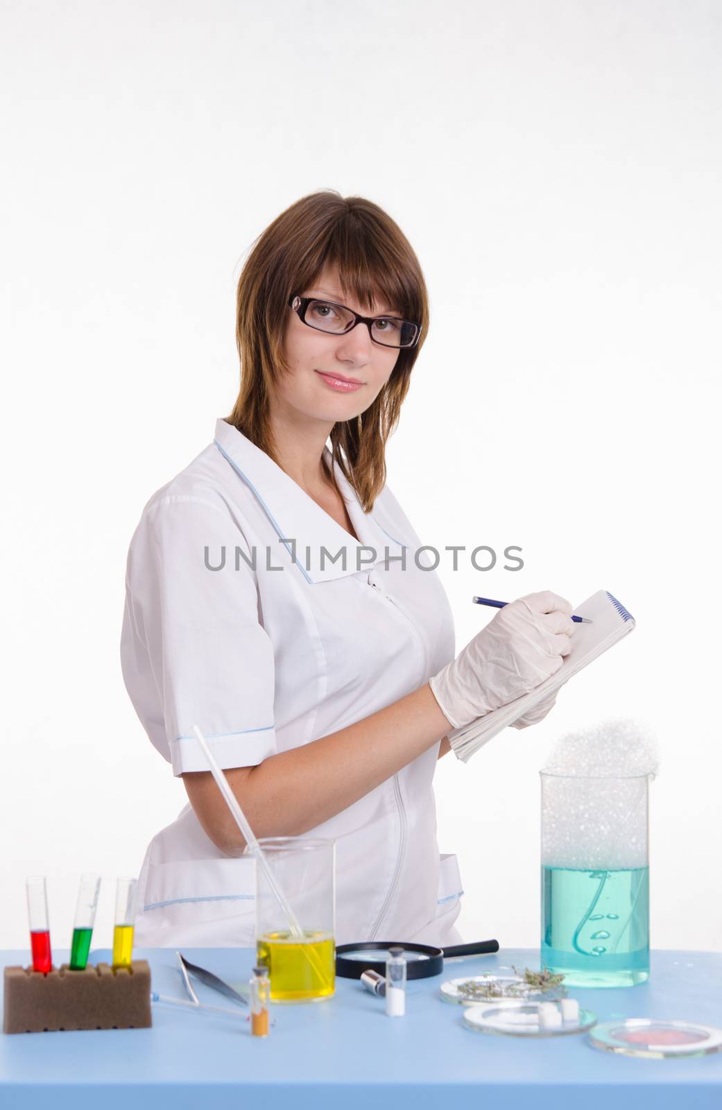 Young beautiful girl posing chemical experiments in the laboratory
