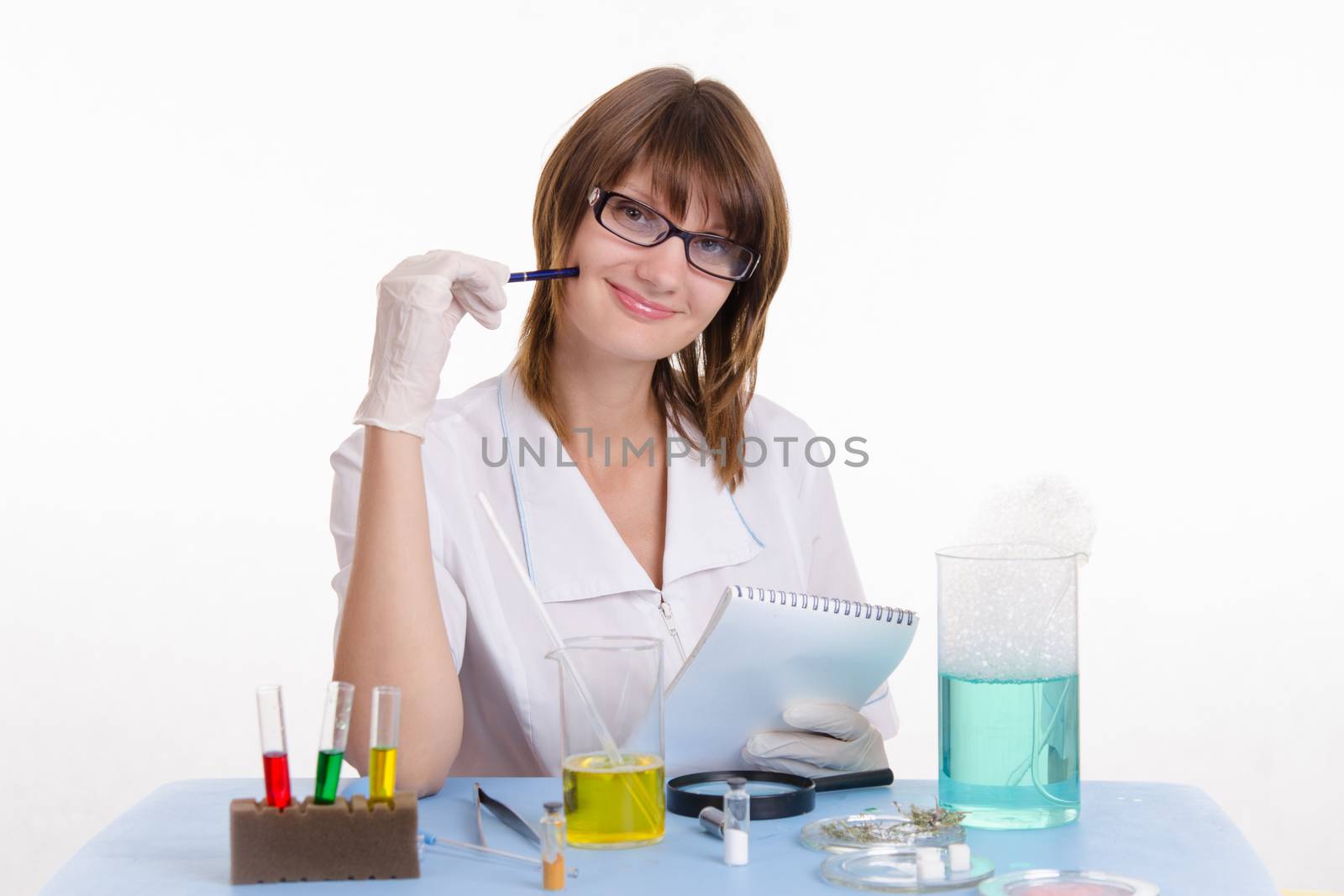 Young beautiful girl posing chemical experiments in the laboratory