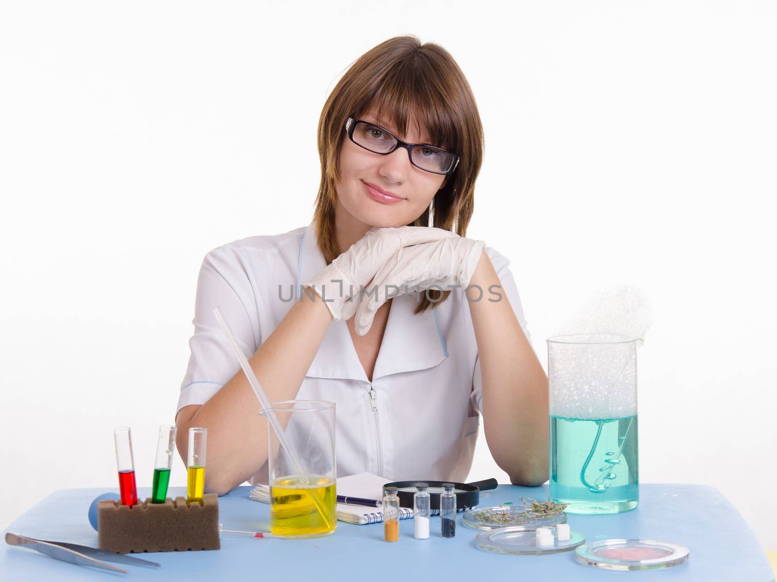Young beautiful girl posing chemical experiments in the laboratory
