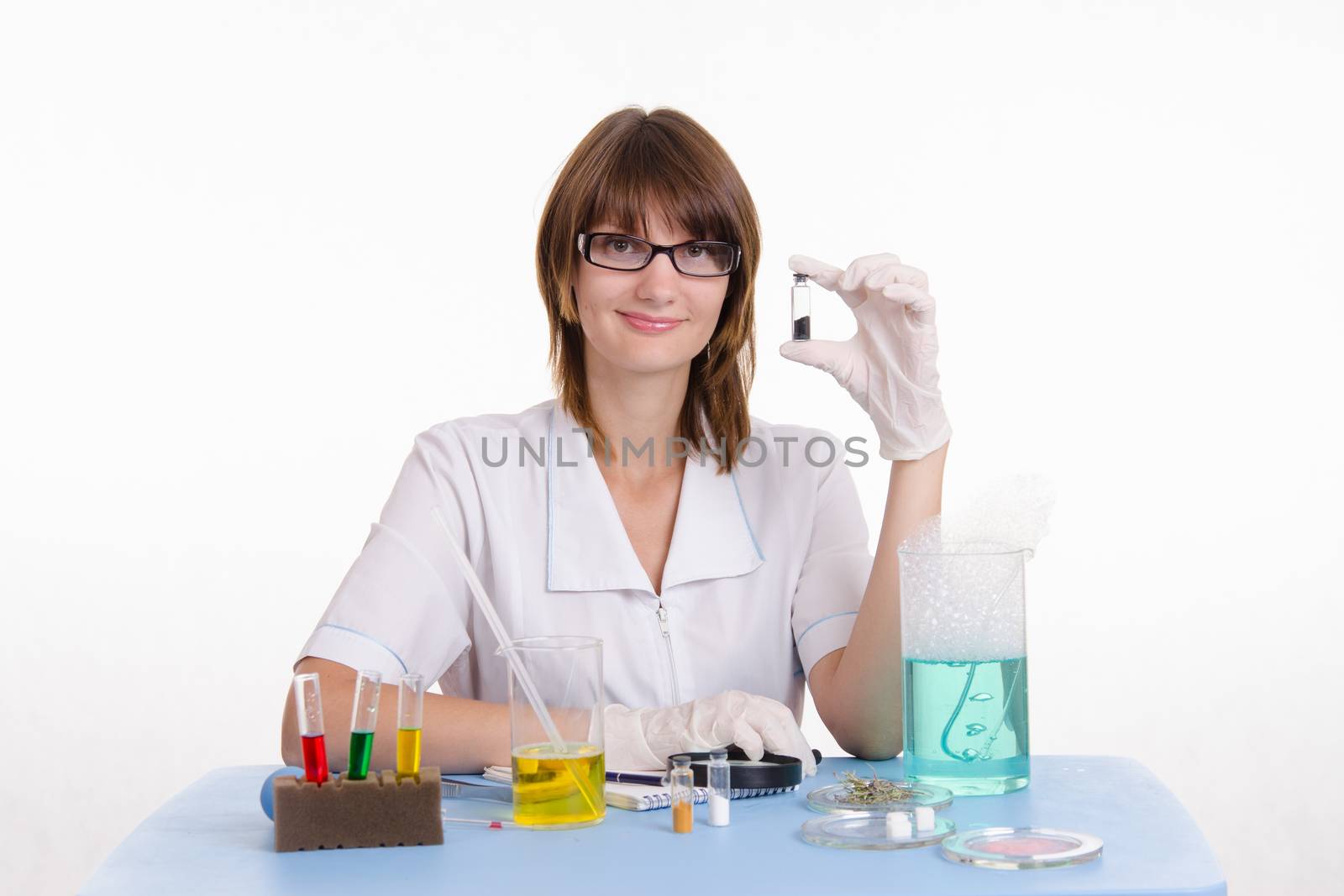 Young beautiful girl posing chemical experiments in the laboratory
