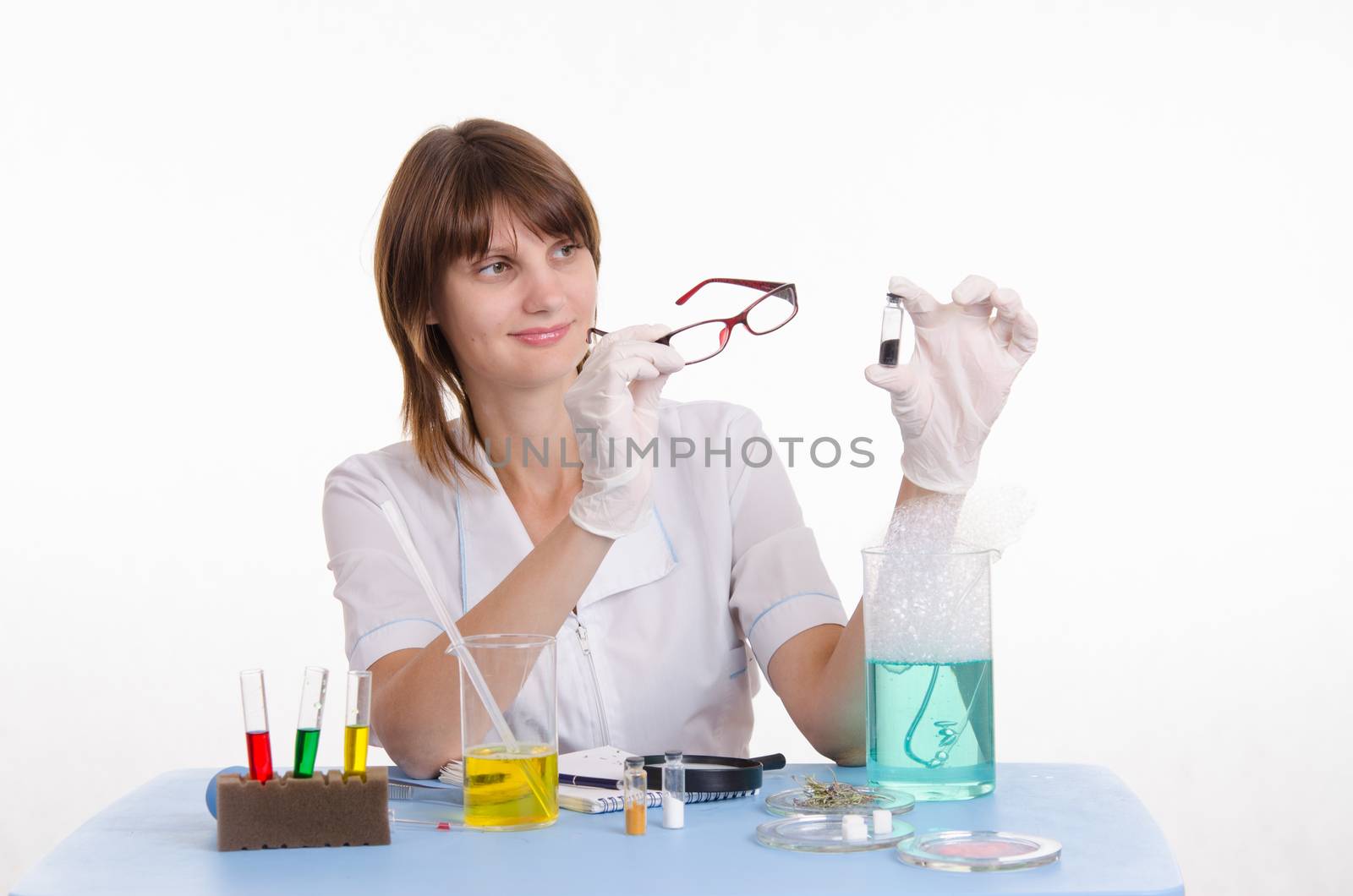 Young beautiful girl posing chemical experiments in the laboratory