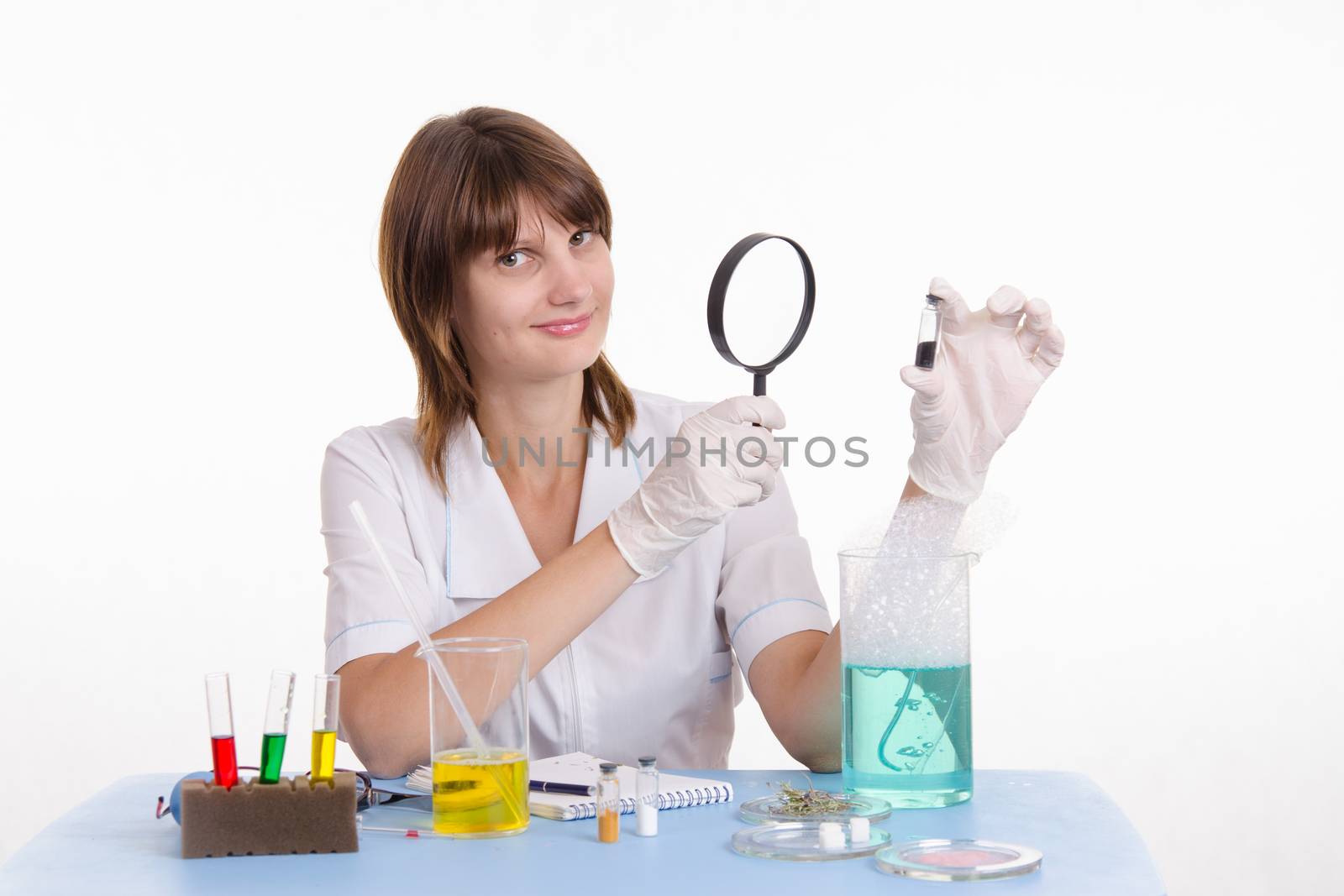 Young beautiful girl posing chemical experiments in the laboratory
