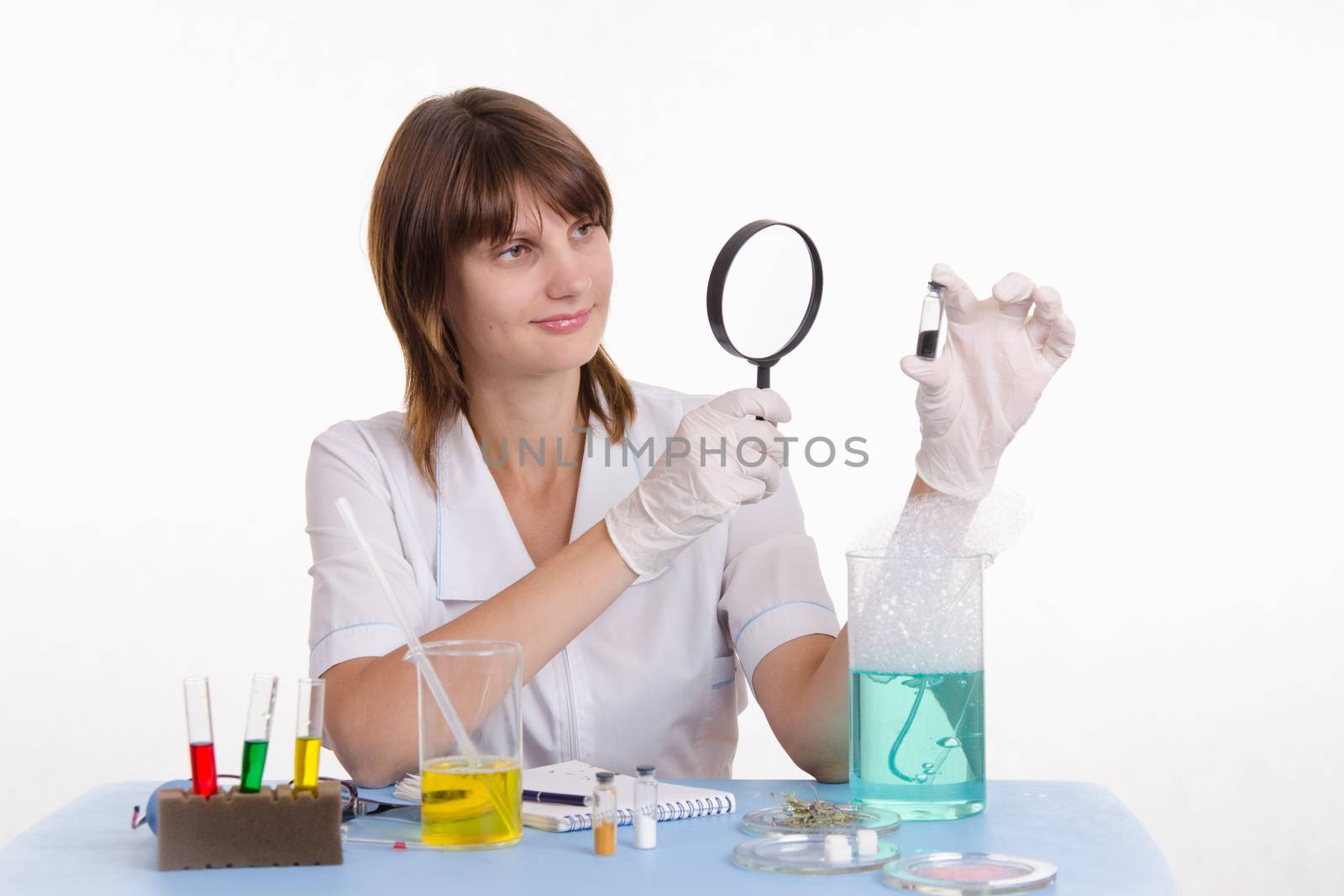 Young beautiful girl posing chemical experiments in the laboratory