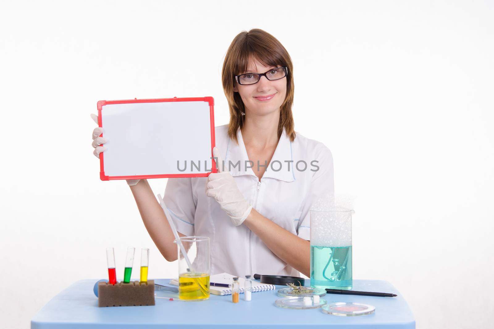 Young beautiful girl posing chemical experiments in the laboratory