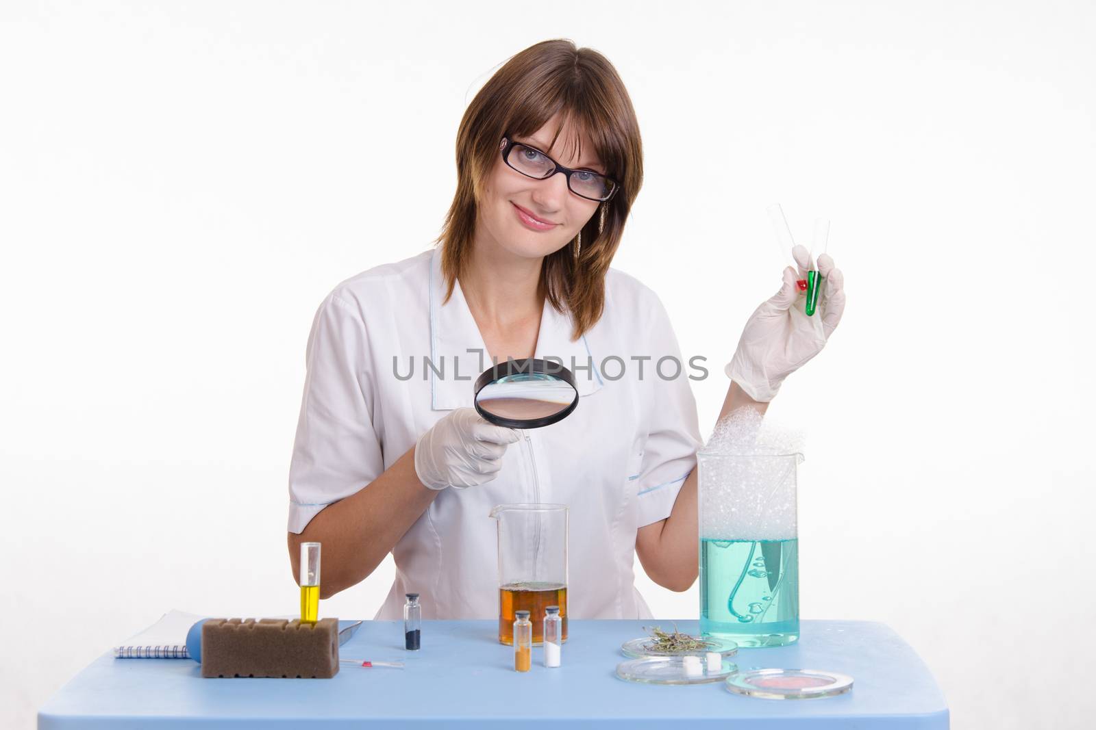 Young beautiful girl posing chemical experiments in the laboratory