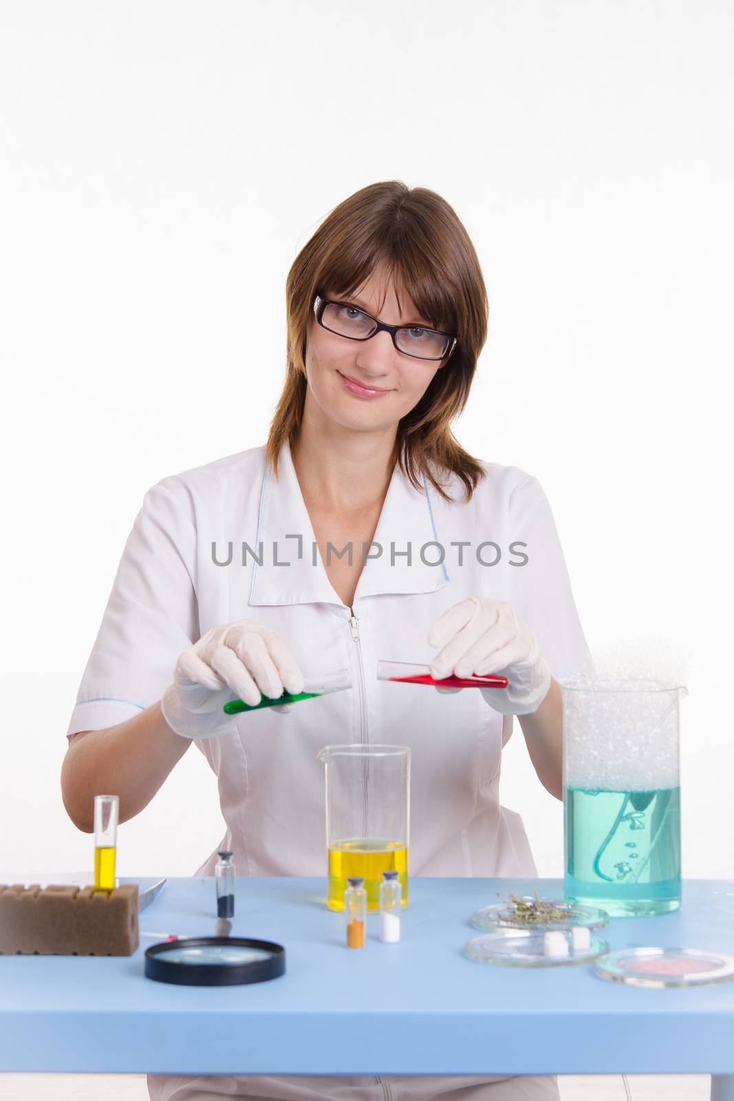 Young beautiful girl posing chemical experiments in the laboratory