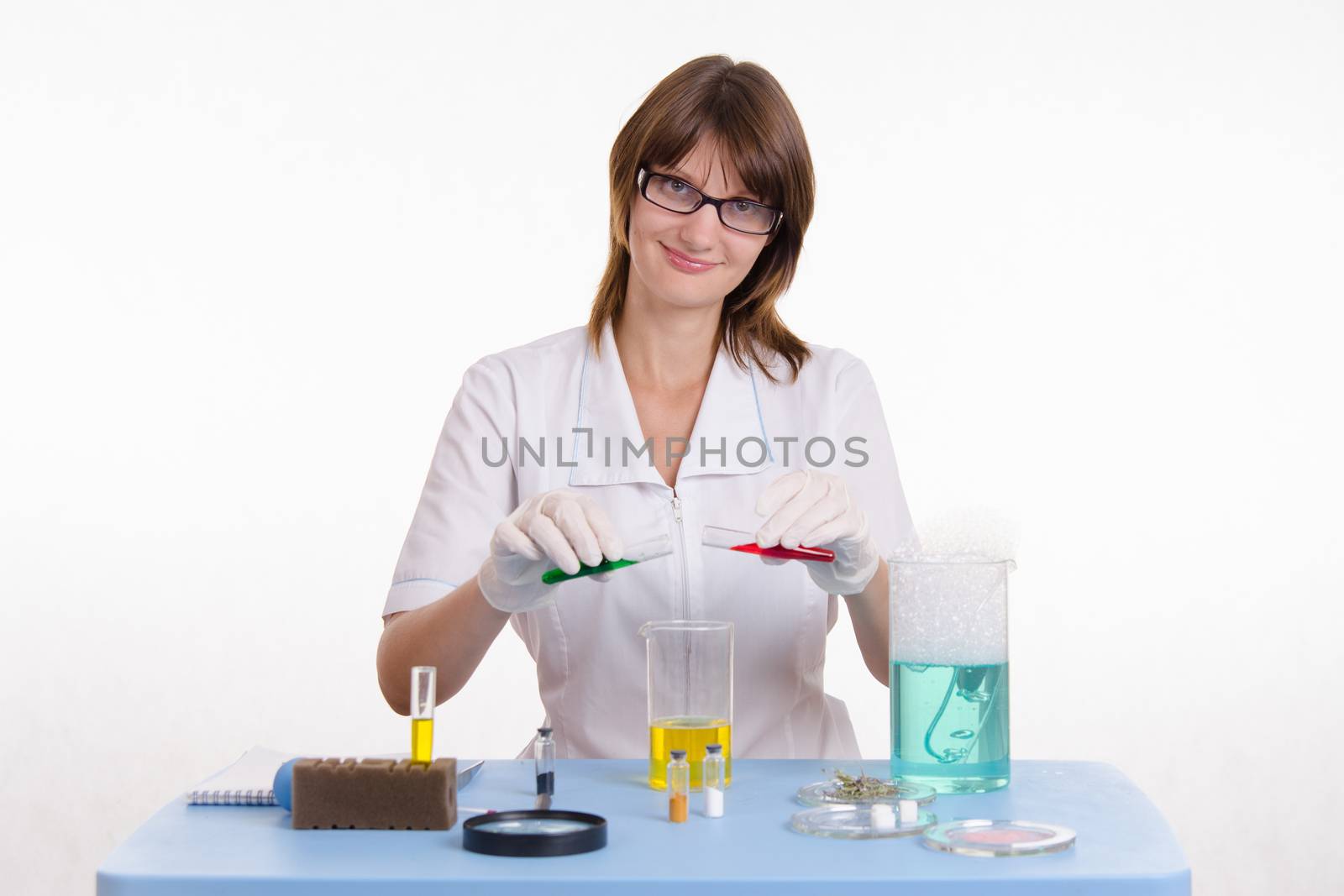 Young beautiful girl posing chemical experiments in the laboratory