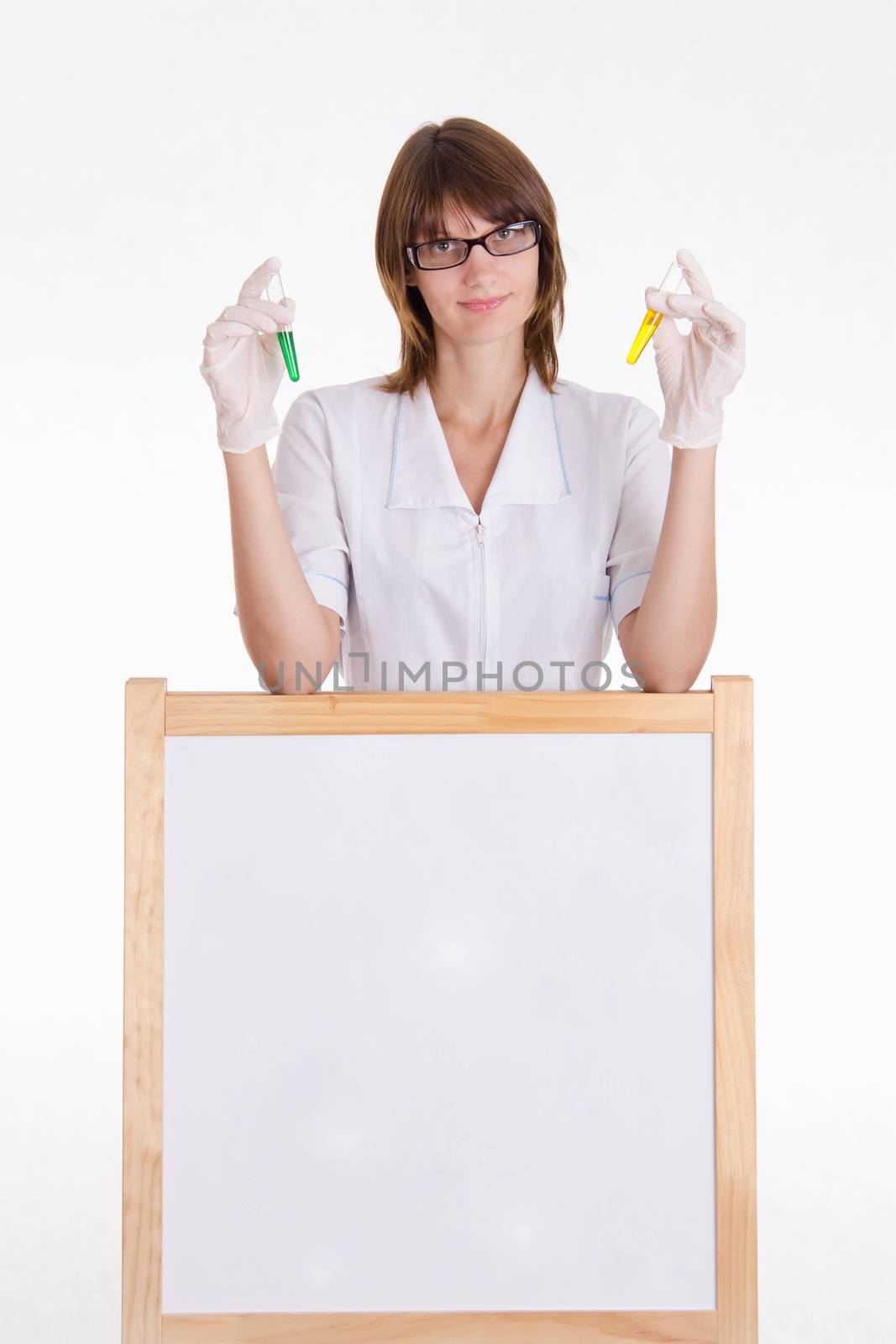 Chemist with test tubes stands at the blackboard with advertising