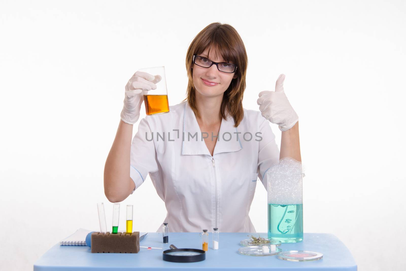 Young beautiful girl posing chemical experiments in the laboratory