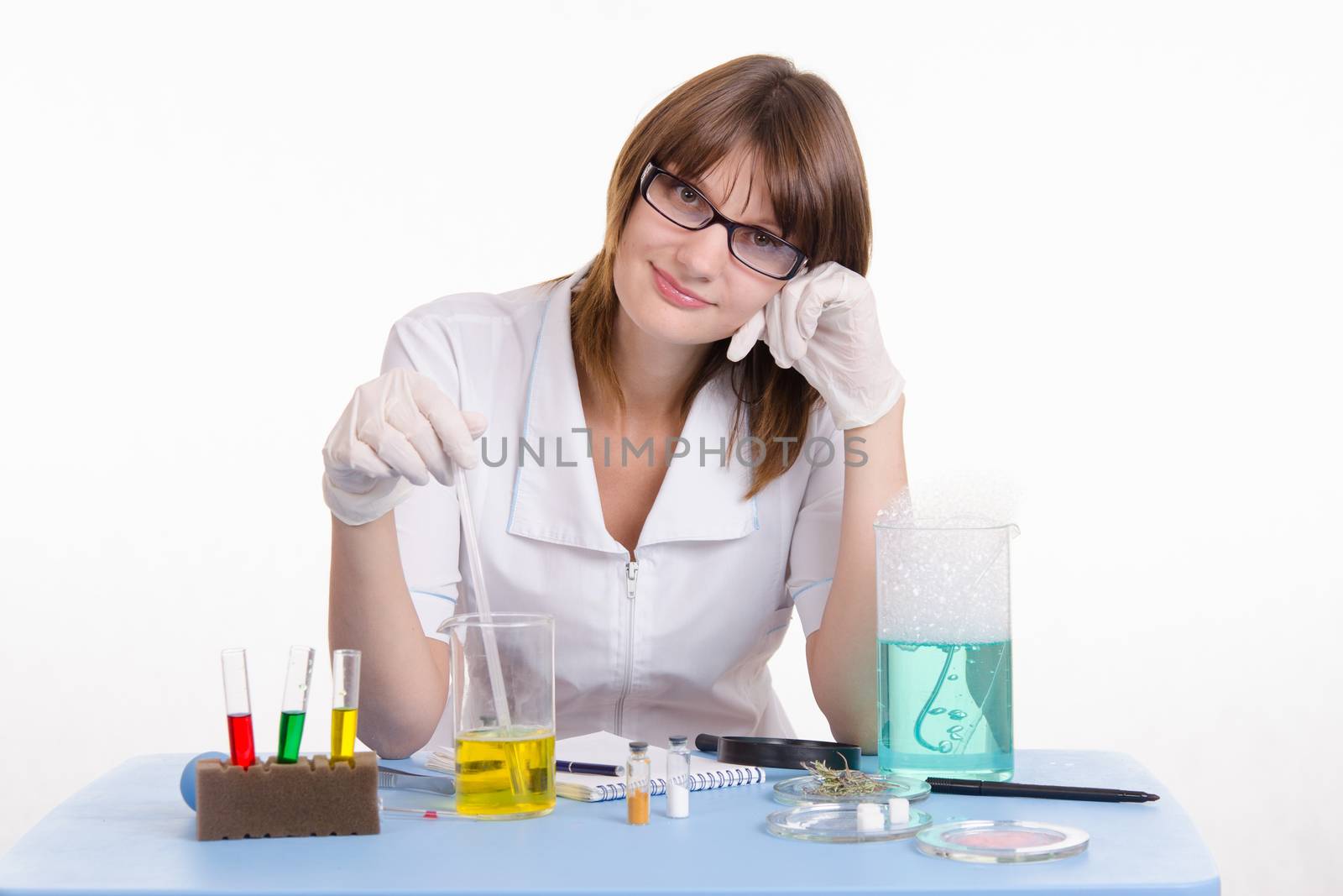 Young beautiful girl posing chemical experiments in the laboratory