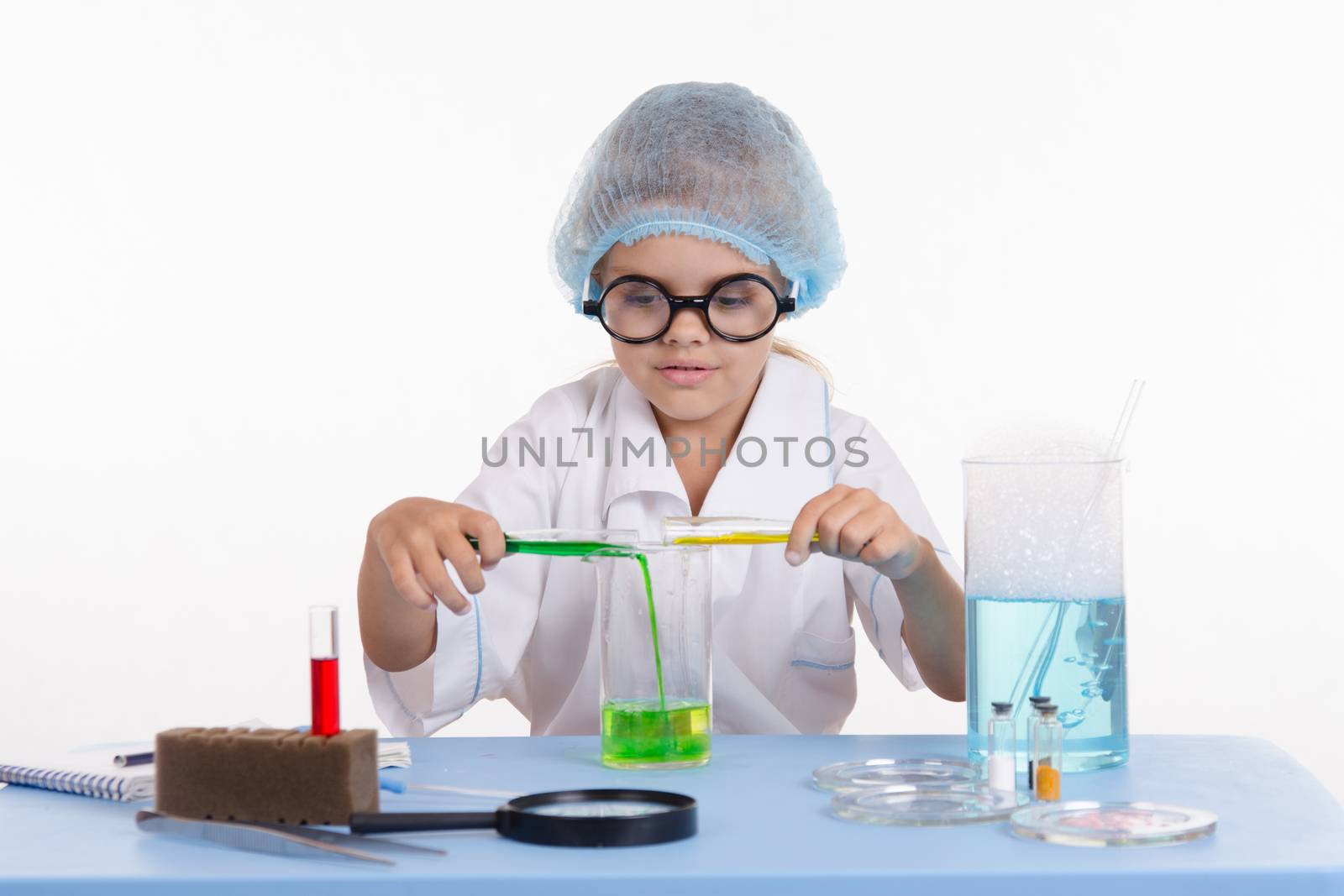 Girl sitting in chemistry class and makes the simplest experiments