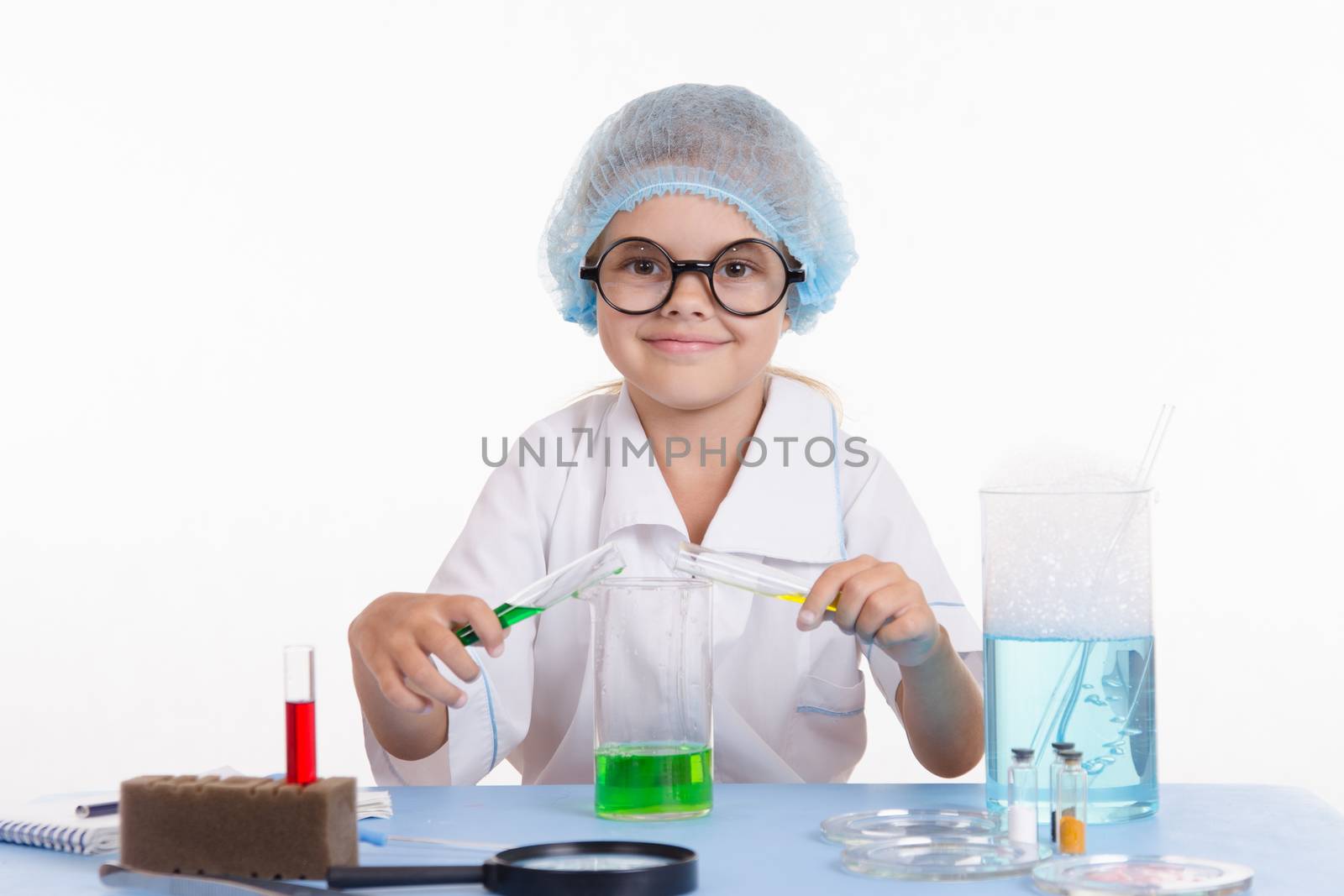 Girl sitting in chemistry class and makes the simplest experiments