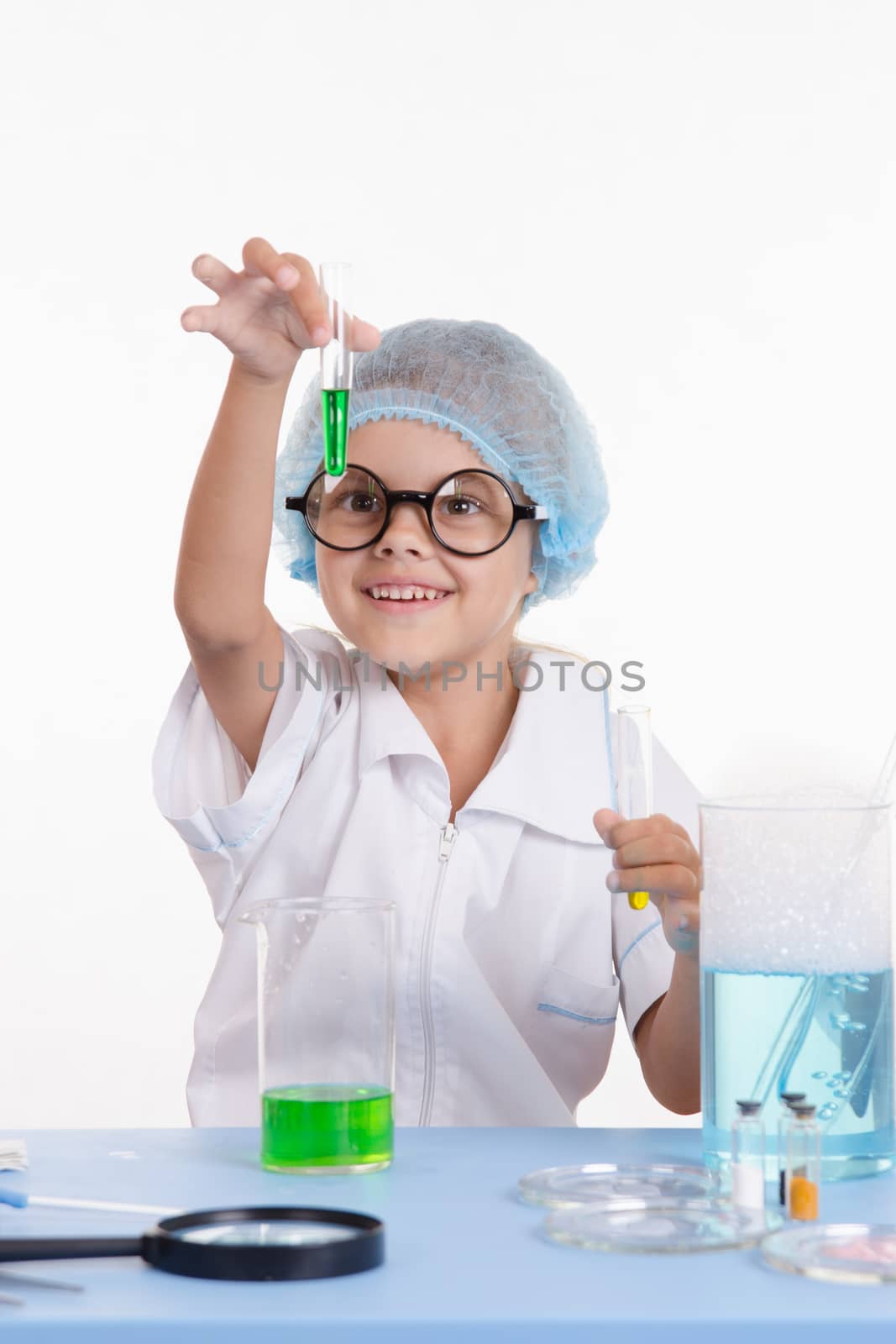 Girl sitting in chemistry class and makes the simplest experiments