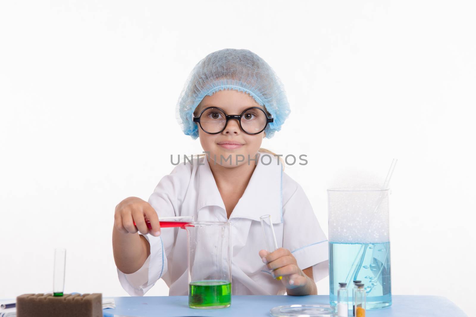 Girl sitting in chemistry class and makes the simplest experiments