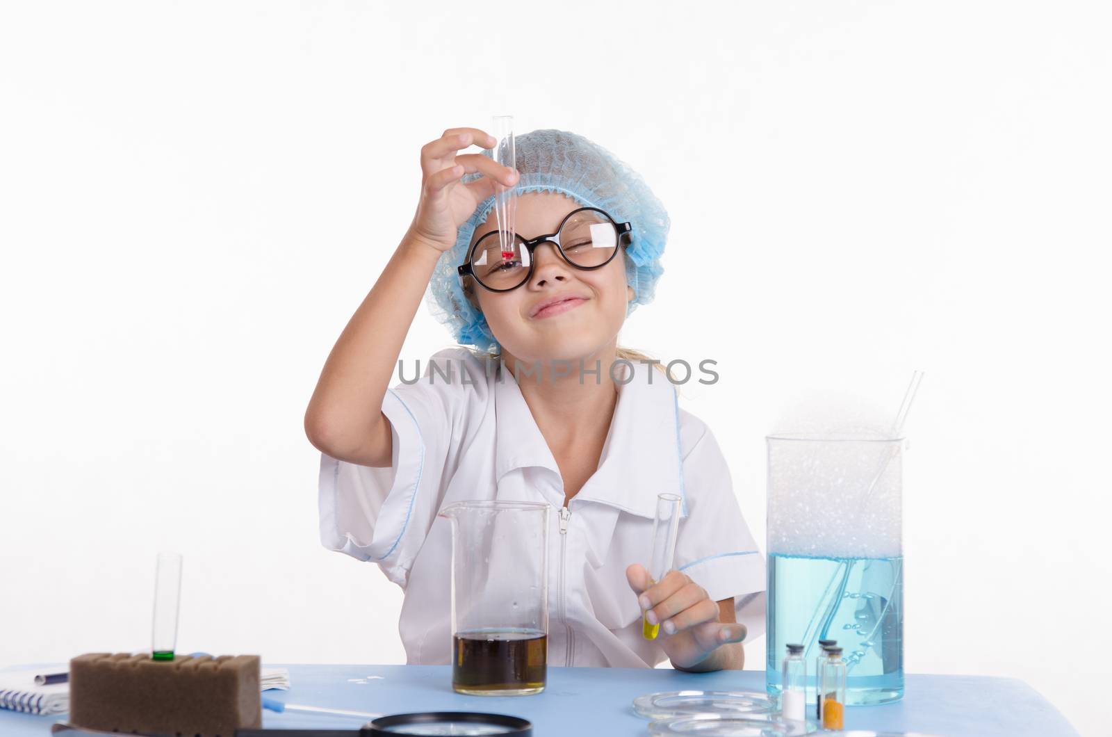 Girl sitting in chemistry class and makes the simplest experiments