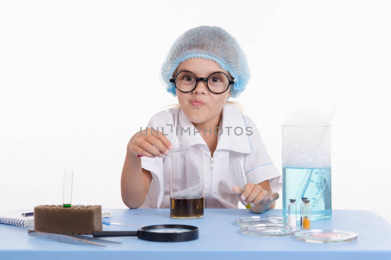 Girl sitting in chemistry class and makes the simplest experiments