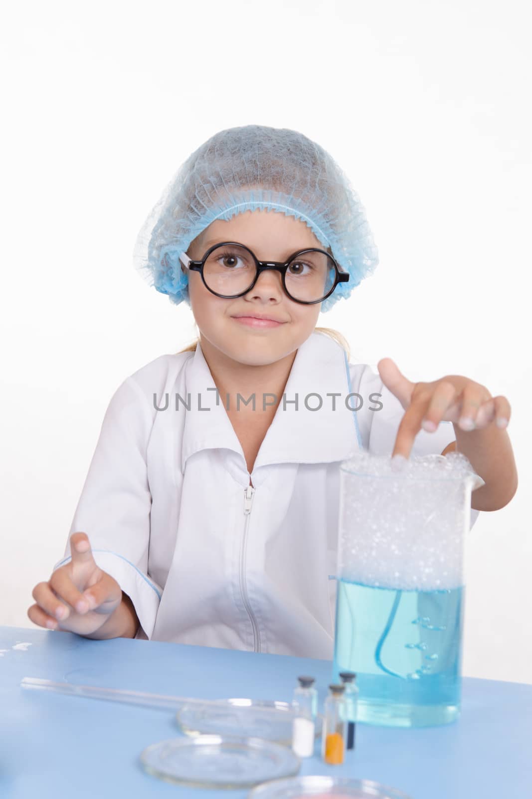 Girl sitting in chemistry class and makes the simplest experiments