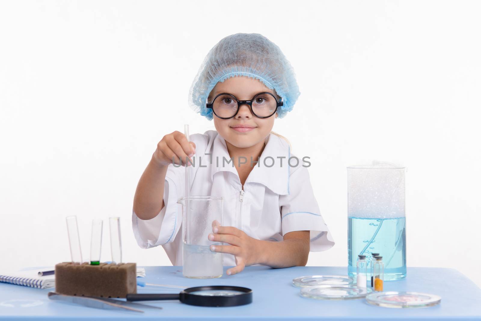 Girl sitting in chemistry class and makes the simplest experiments