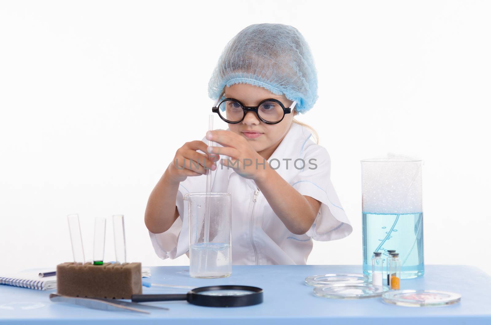 Girl sitting in chemistry class and makes the simplest experiments