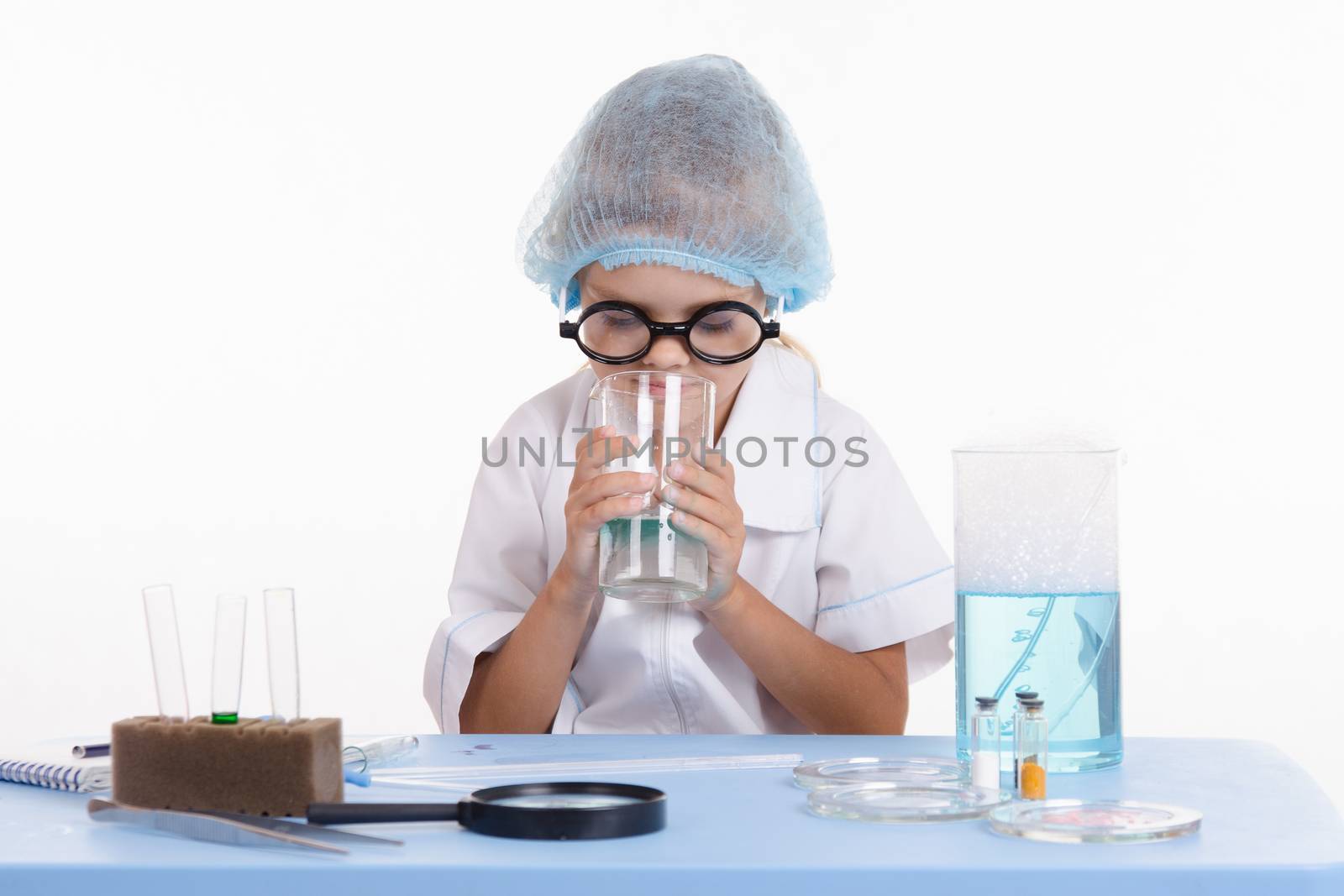 Girl sitting in chemistry class and makes the simplest experiments