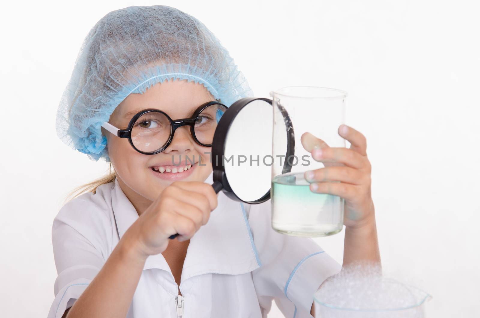 Girl sitting in chemistry class and makes the simplest experiments